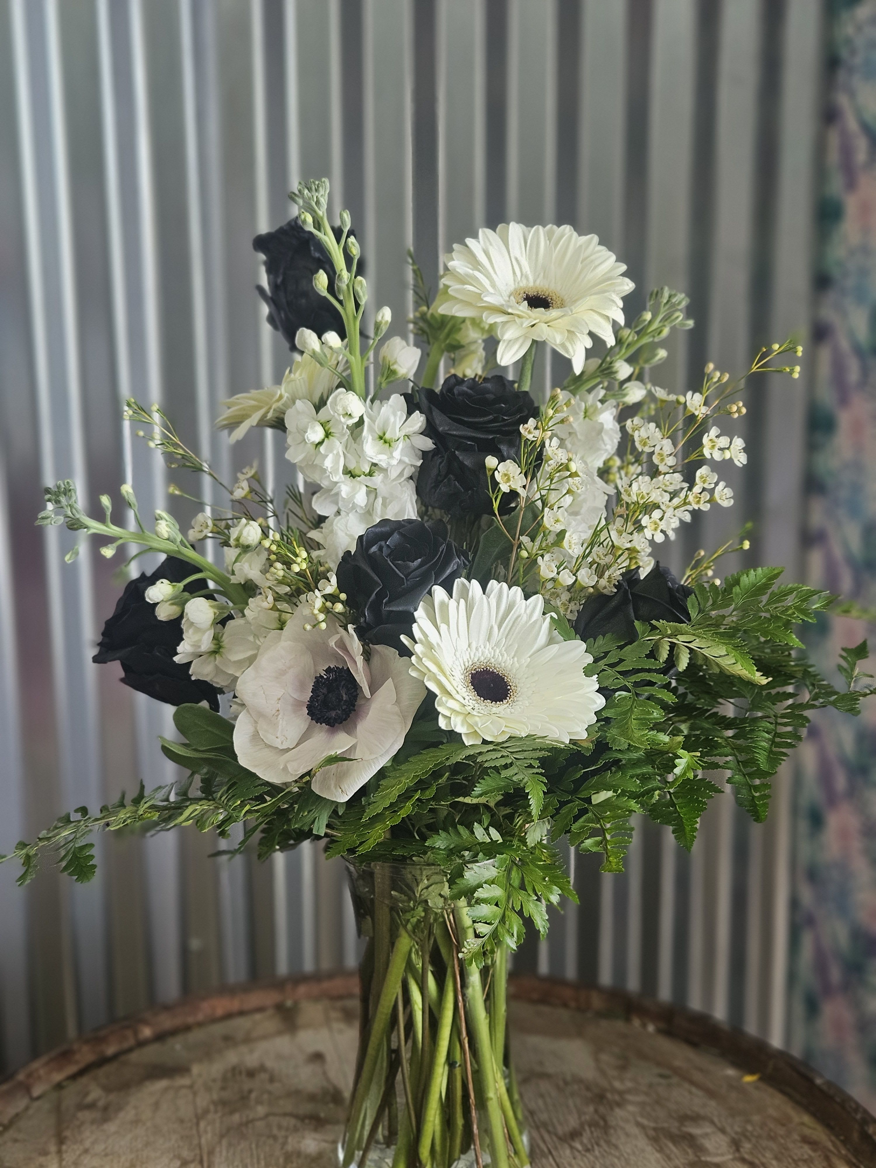 Black and white flower bouquet in a clear glass vase