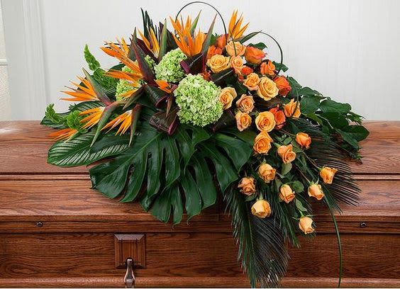 Tropical floral casket spray with orange roses and green hydrangeas