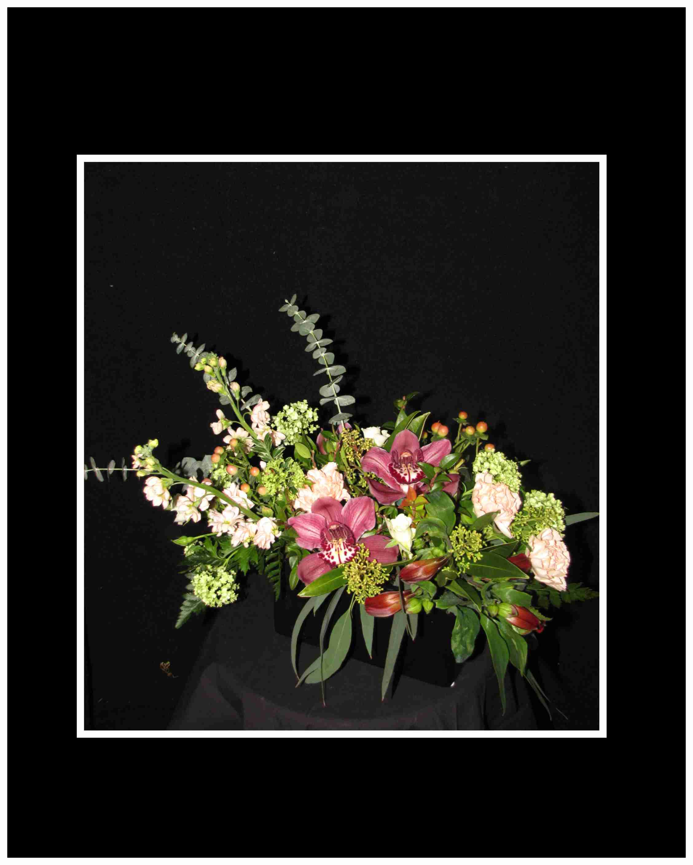 At Last Arrangement - Spray roses, with Cymbidium blossoms and Peruvian lilies gently set into a ceramic container