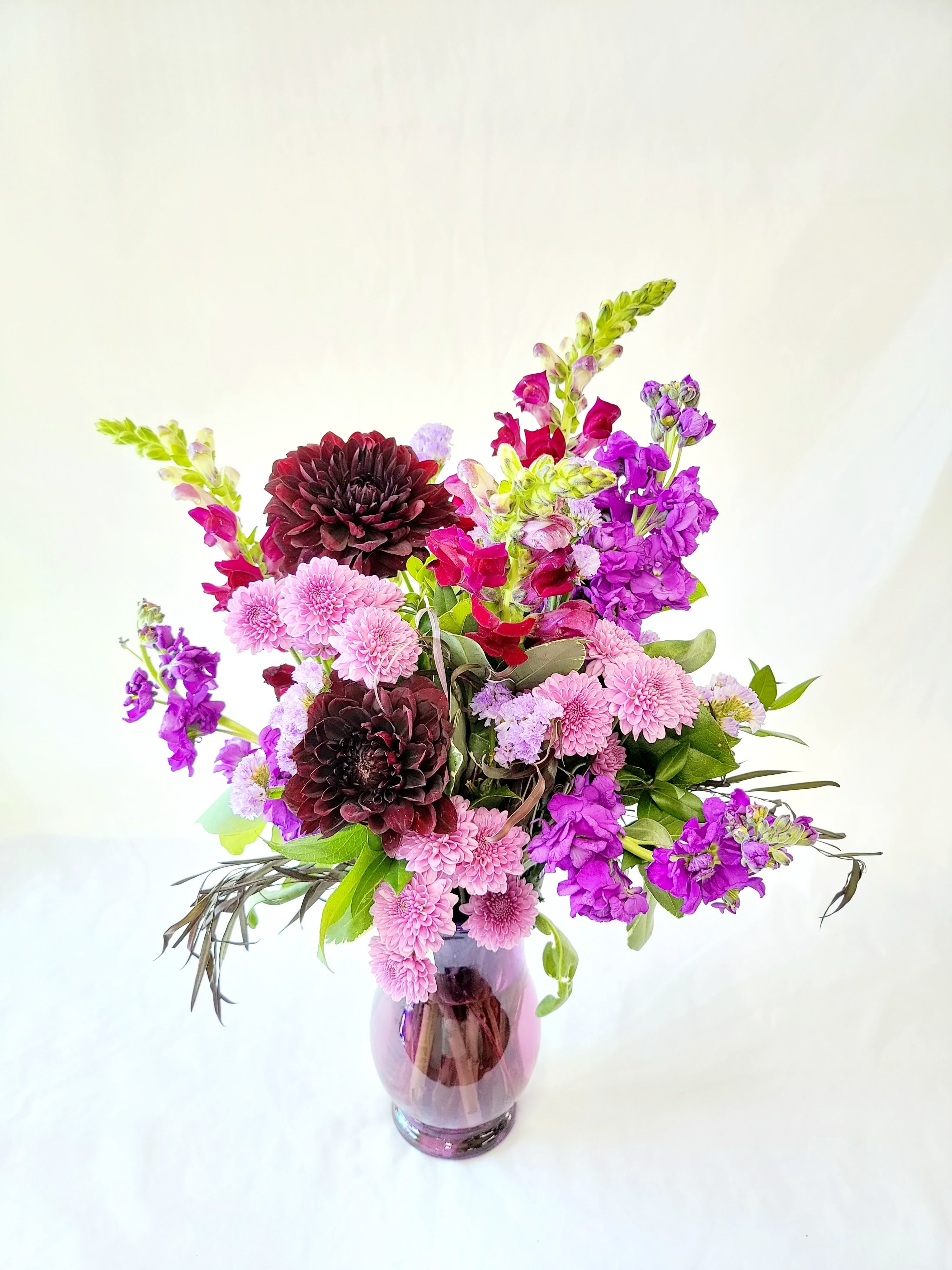 Grape Soda - Select this fun arrangement of purple and lavender tones. Flowers include dahlias, snapdragons, stock and more. 