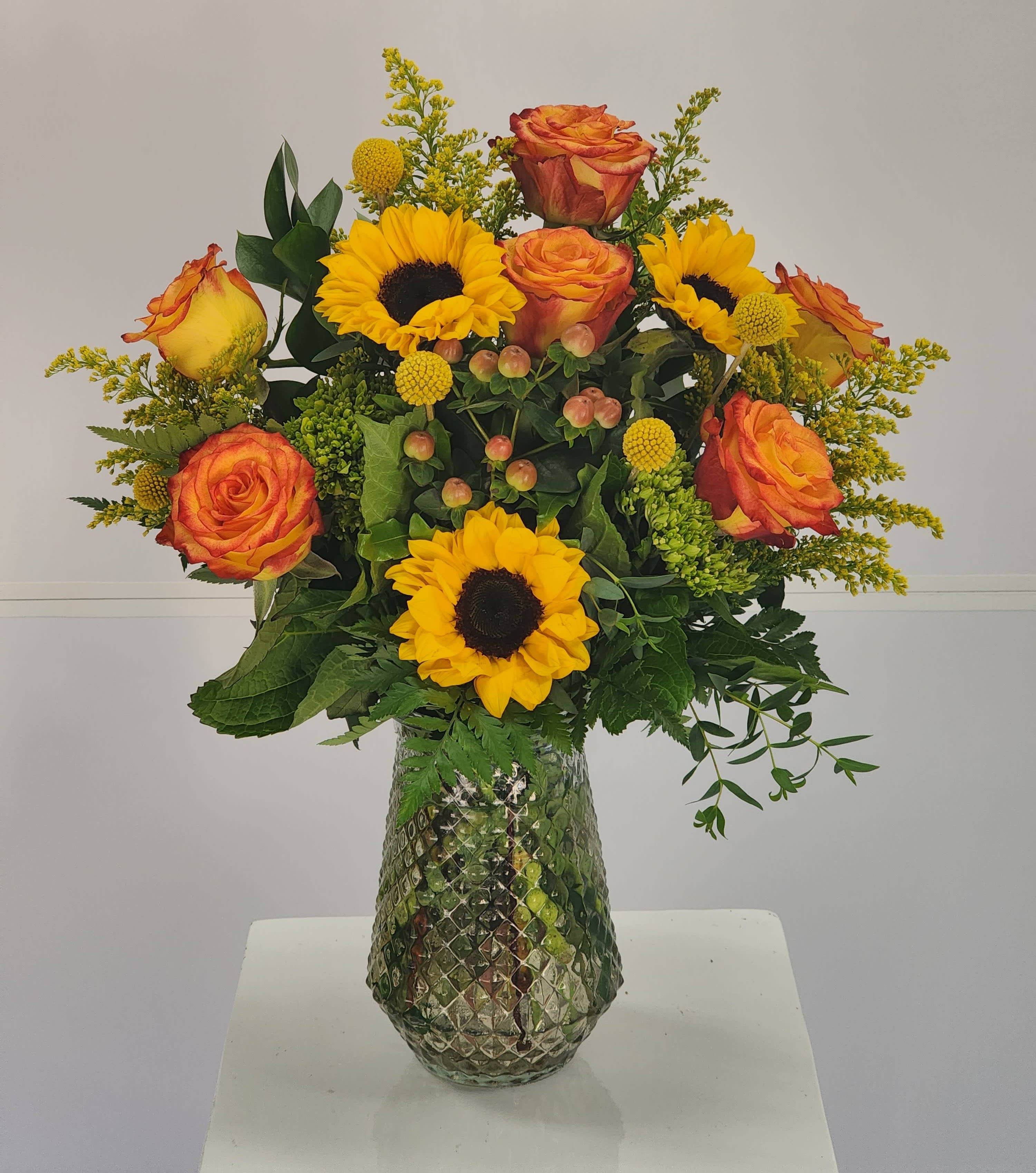 Firefly - Select this beautiful arrangement featuring sunflowers, roses, hypericum, and more! 
