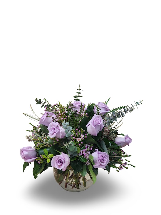 Lavender Rose Bowl - A graceful arrangement of one dozen lavender roses, their soft petals symbolizing love and enchantment. Nestled in a charming bowl, these blooms are beautifully complemented by delicate filler flowers, adding texture and elegance. A timeless and romantic display, perfect for expressing admiration, appreciation, or heartfelt affection.