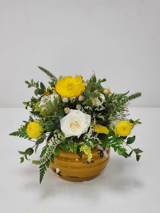 Beehive - Select this unique beehive arrangement with a plethora of flowers including white spray roses, yellow ranunculus, yellow yarrow, white veronica, white hypericum, solidago and misty.  Approximately 9" x 8"