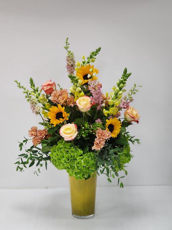 Sun Rays - Select this summer filled arrangement featuring sunflowers, hydrangea, roses, snap dragons and more!  Approx. 31" tall by 15" wide. 
