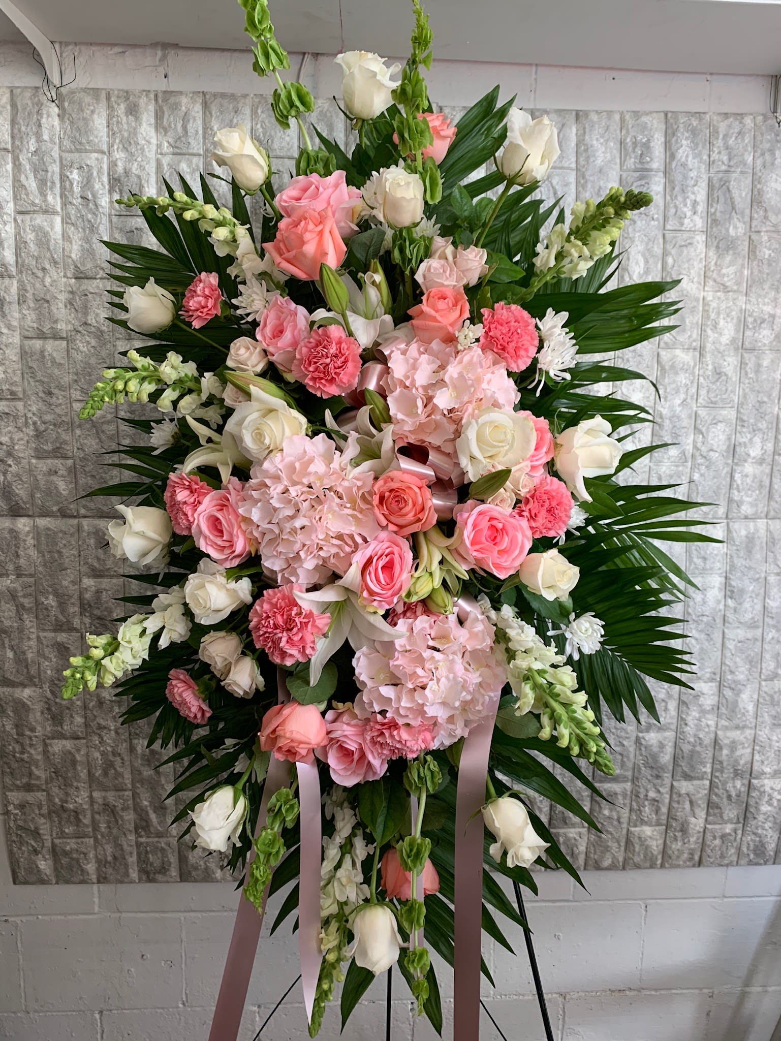 Standing floral spray with pink and white roses and carnations