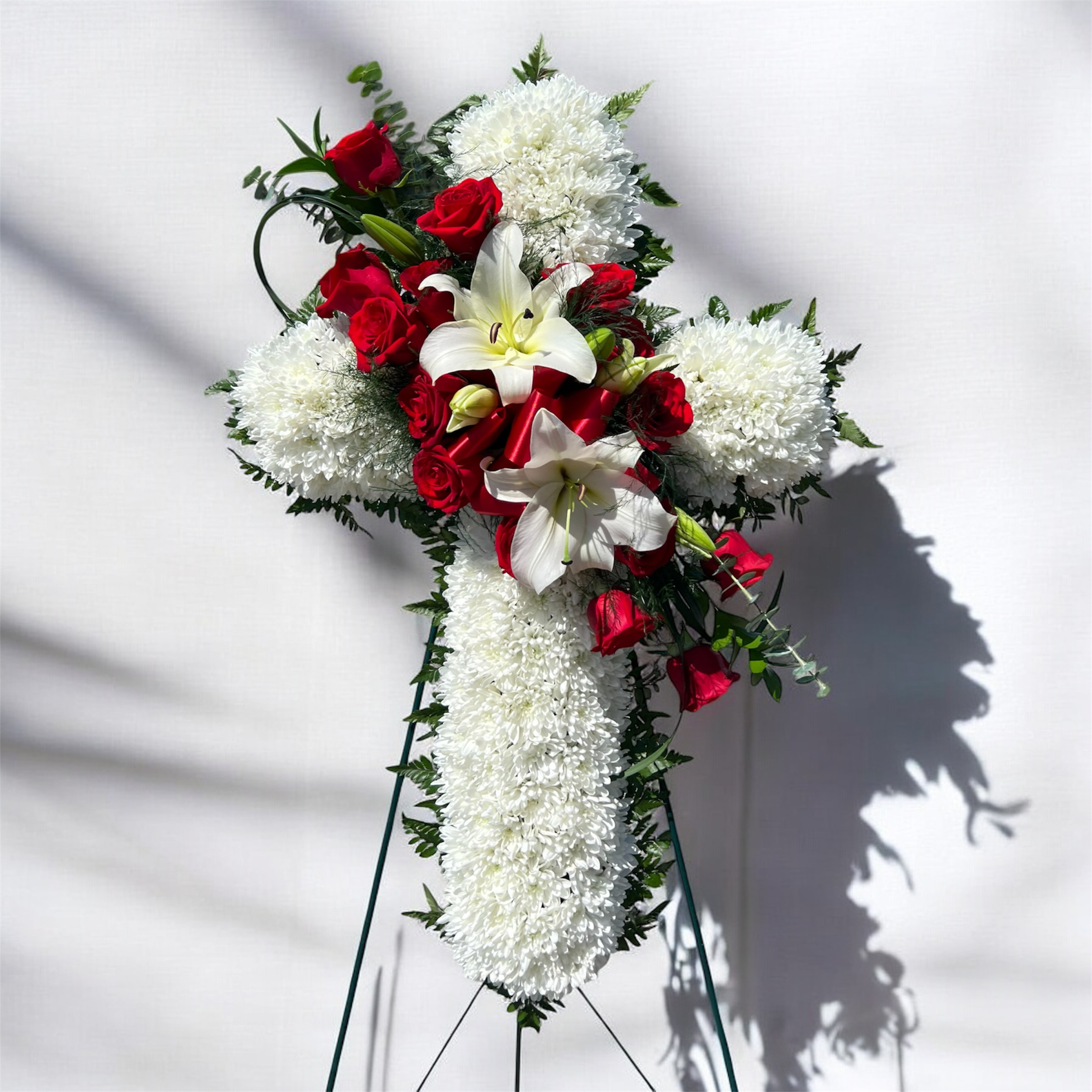 Standing floral spray with red roses, white lilies, and white chrysanthemums