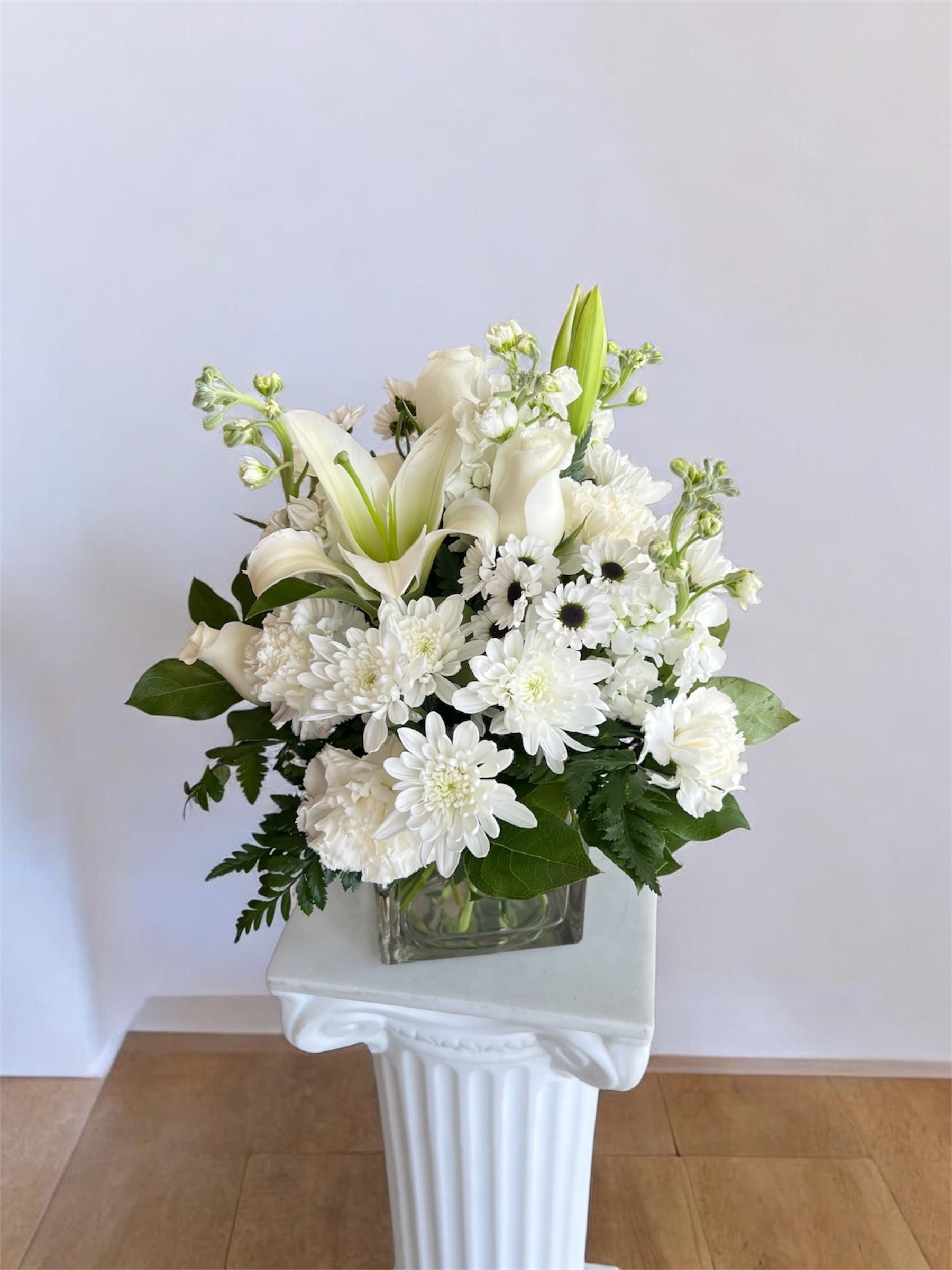 The White Muse  - A timeless all-white arrangement featuring elegant blooms, designed to bring a sense of purity, grace and effortless sophistication- suited for any occasion! 
