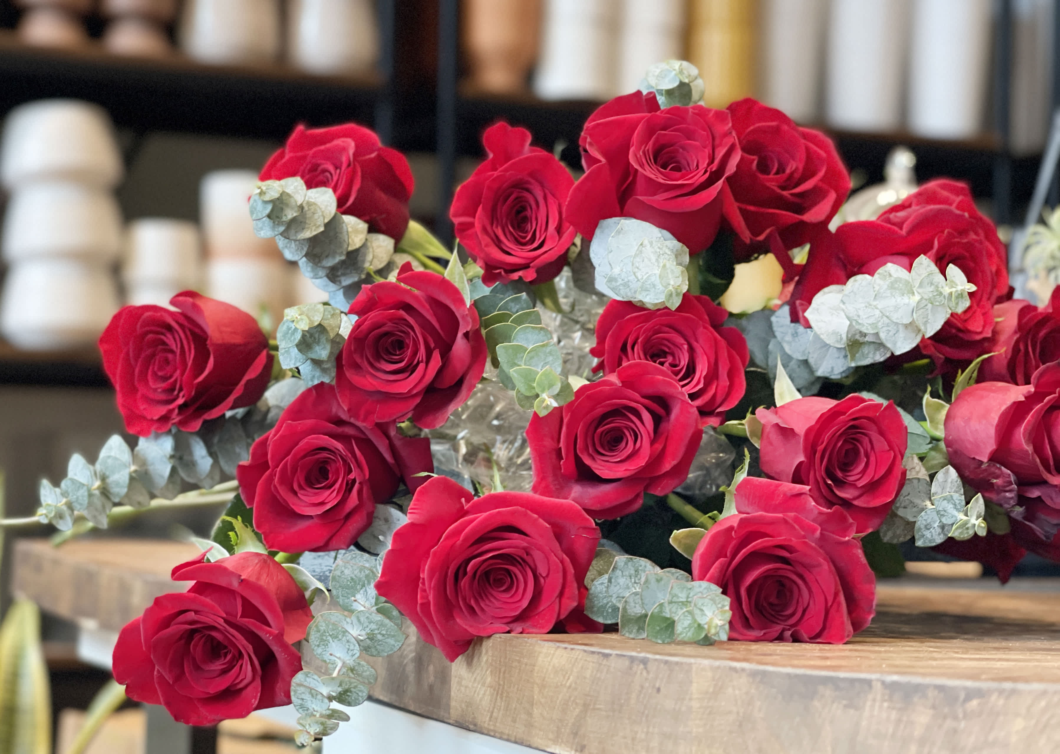 Bouquet of red roses with pale blue eucalyptus