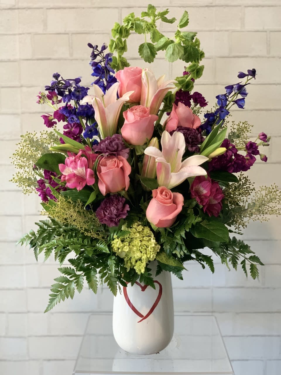 Blooming Extravaganza  - This Arrangement is stunning and expansive floral arrangement designed to impress. This lavish display features a harmonious blend of vibrant colors, diverse textures, and varying heights, creating a visual masterpiece. Vase may vary    