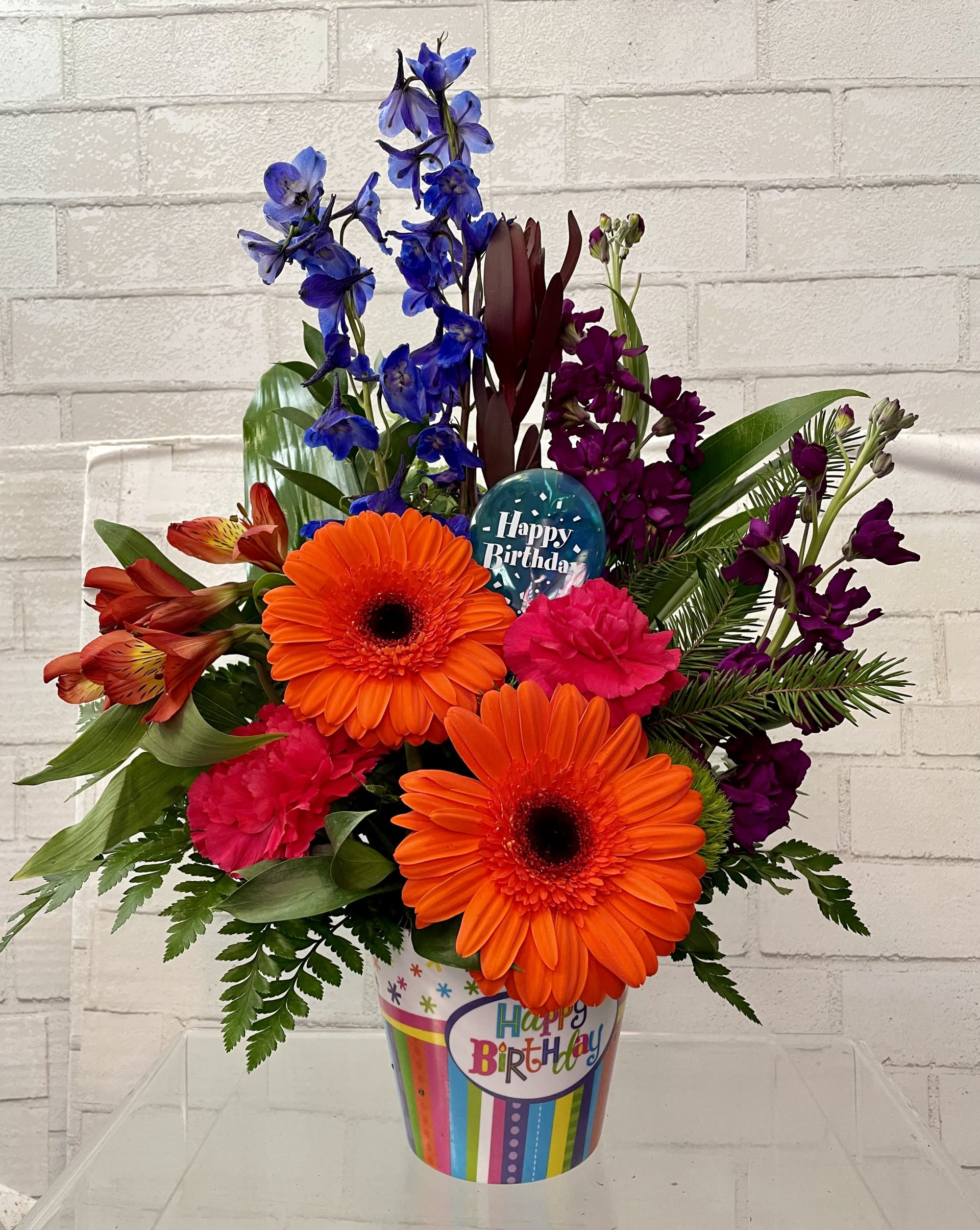 Hip Hip Hooray!  - Why not offer a rousing "Hooray!" to someone with something to celebrate, It's easy! Just send this Happy Birthday container filled with a brightly hued bouquet. Gerbera colors may vary.   