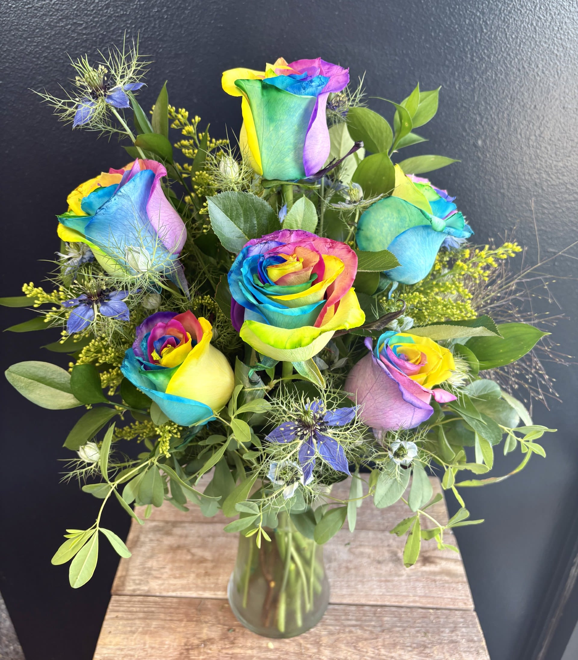 Totally Tie-Dye  - A burst of color and joy, this tie‑dye rose arrangement features swirling rainbow petals that look hand‑painted by nature. Each bloom blends bold hues in a playful, one‑of‑a‑kind pattern, creating an arrangement that feels energetic, happy, and full of personality. Perfect for celebrations, gifts, or anyone who loves color.
