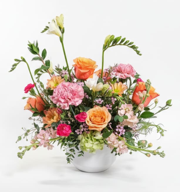 Warm Pastels - Mix of Spring-Garden-like flowers, peaches, pinks, light greens with subtle scents of Stock, Freesia Carnations, Roses and Waxflower make this a definite must have!