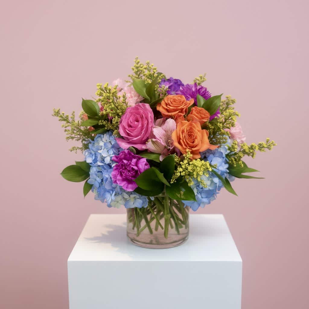 Colorful bouquet of roses and hydrangeas in a glass vase