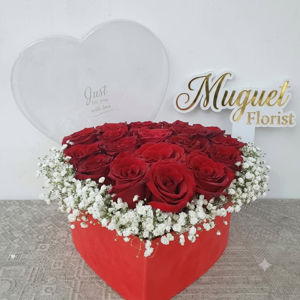 Heart-shaped box of red roses with white baby's breath