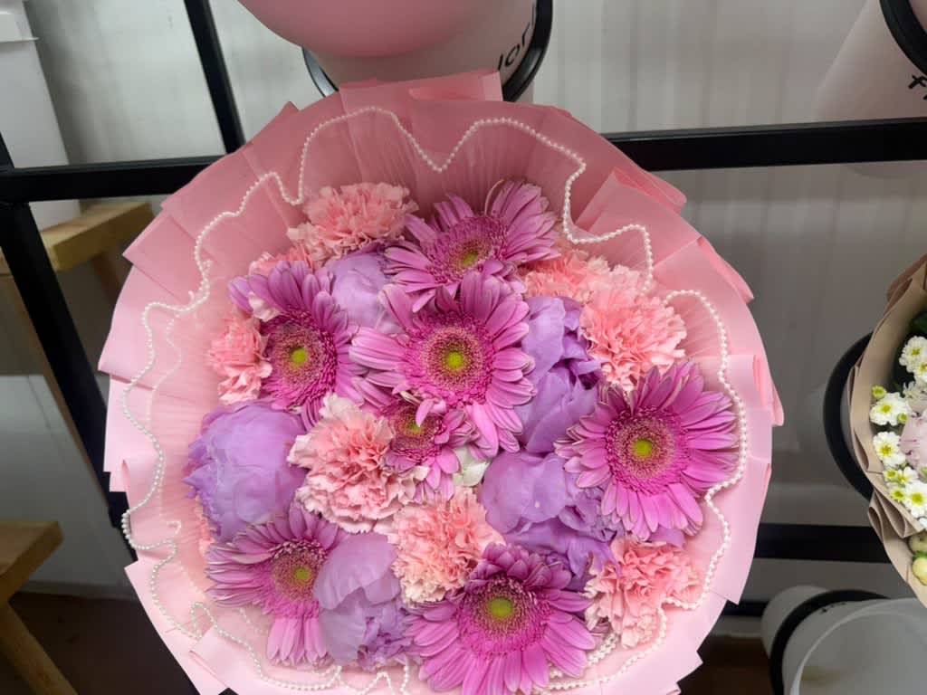 Pink and lavender bouquet with gerbera daisies and carnations wrapped in pink paper