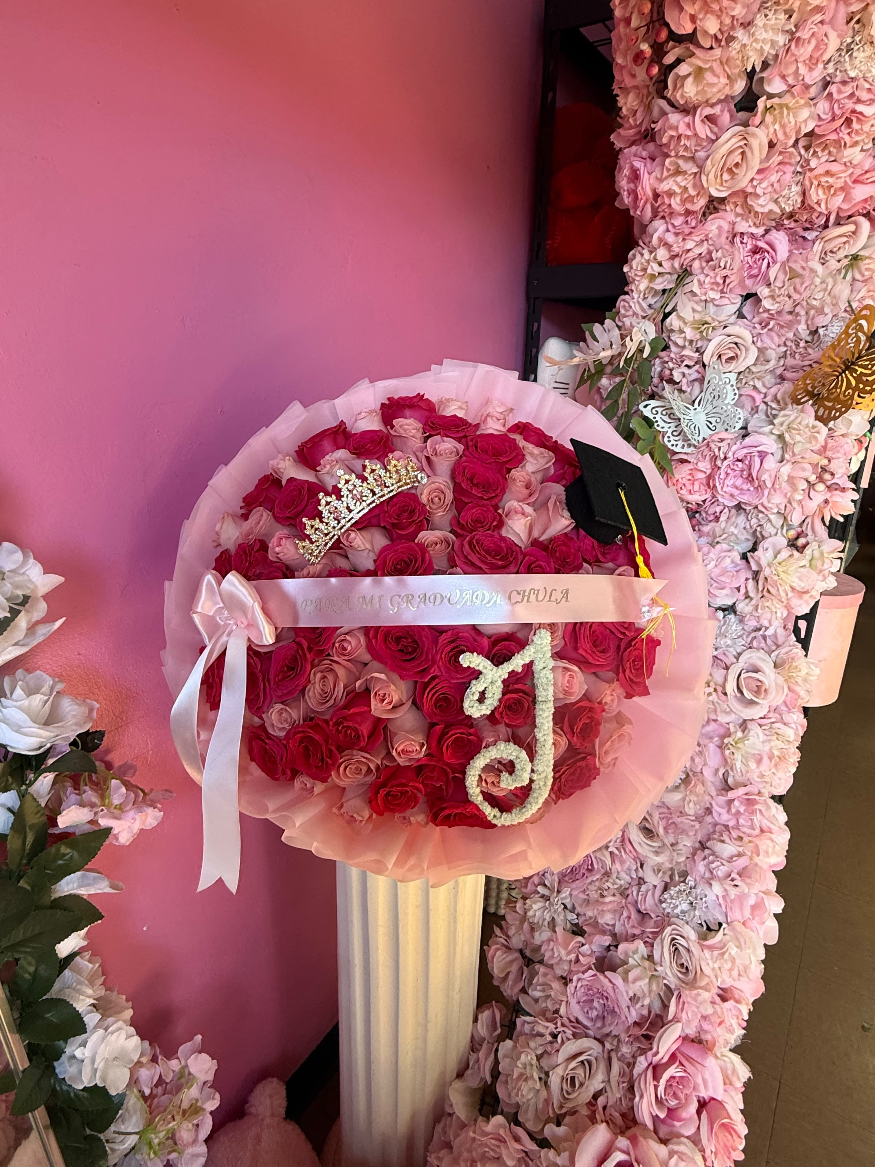 Pink and red rose bouquet with a graduation cap and tiara