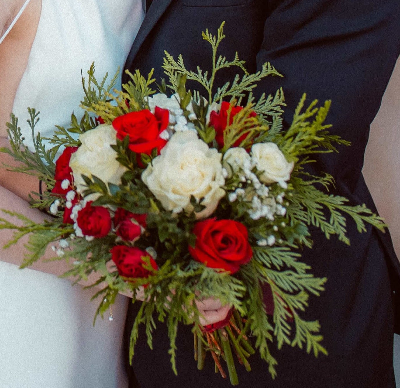 Winter Wedding Bouquet - Winter Greens set the tone for this gorgeous red and white rose bouquet