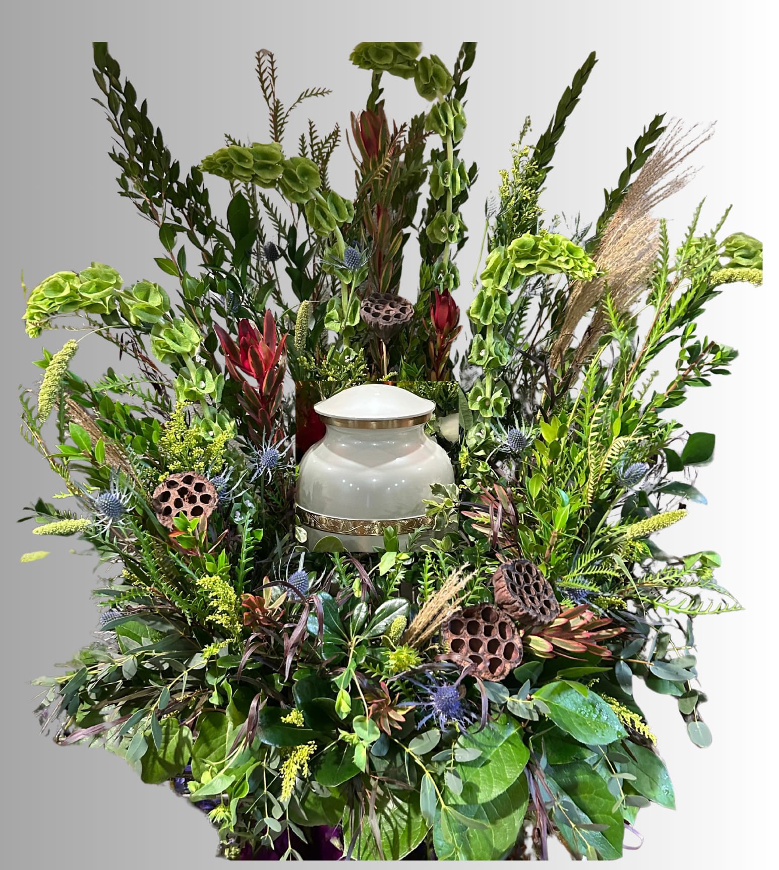 Large floral funeral spray with a white urn in the center