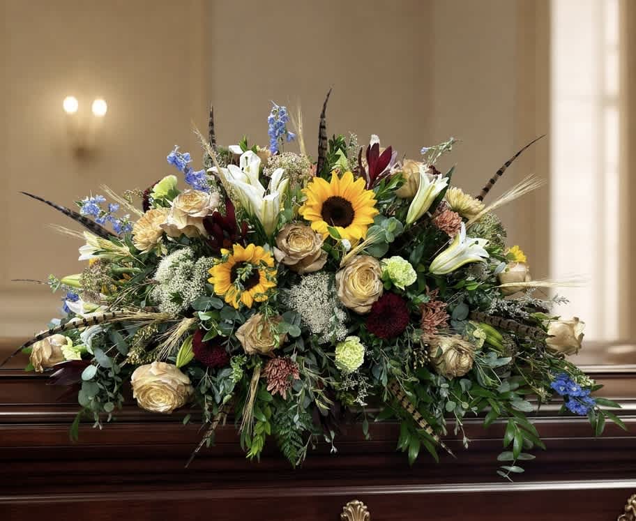 Large casket spray with sunflowers, lilies, and roses