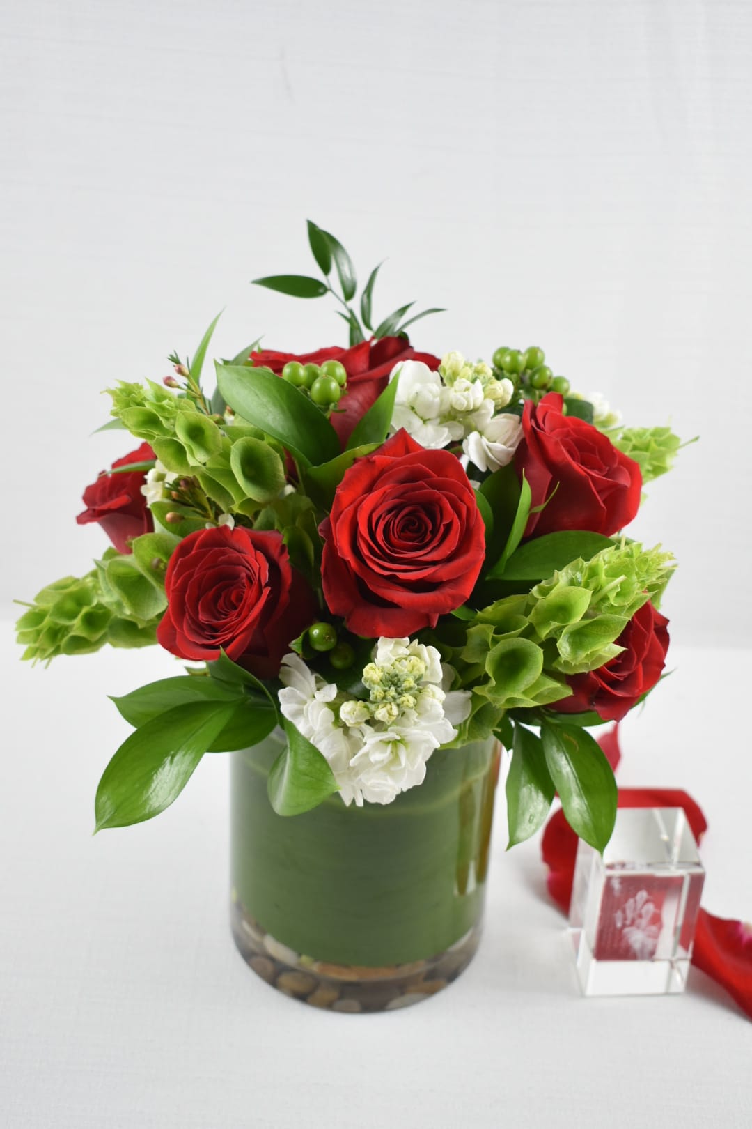 love is perfect - This Perfect small arrangement to demonstrate your love  It comes it a cylinder vase with 8 roses, white stock, bells all well arranged with some greenery This arrangement is the perfect size for a desk  