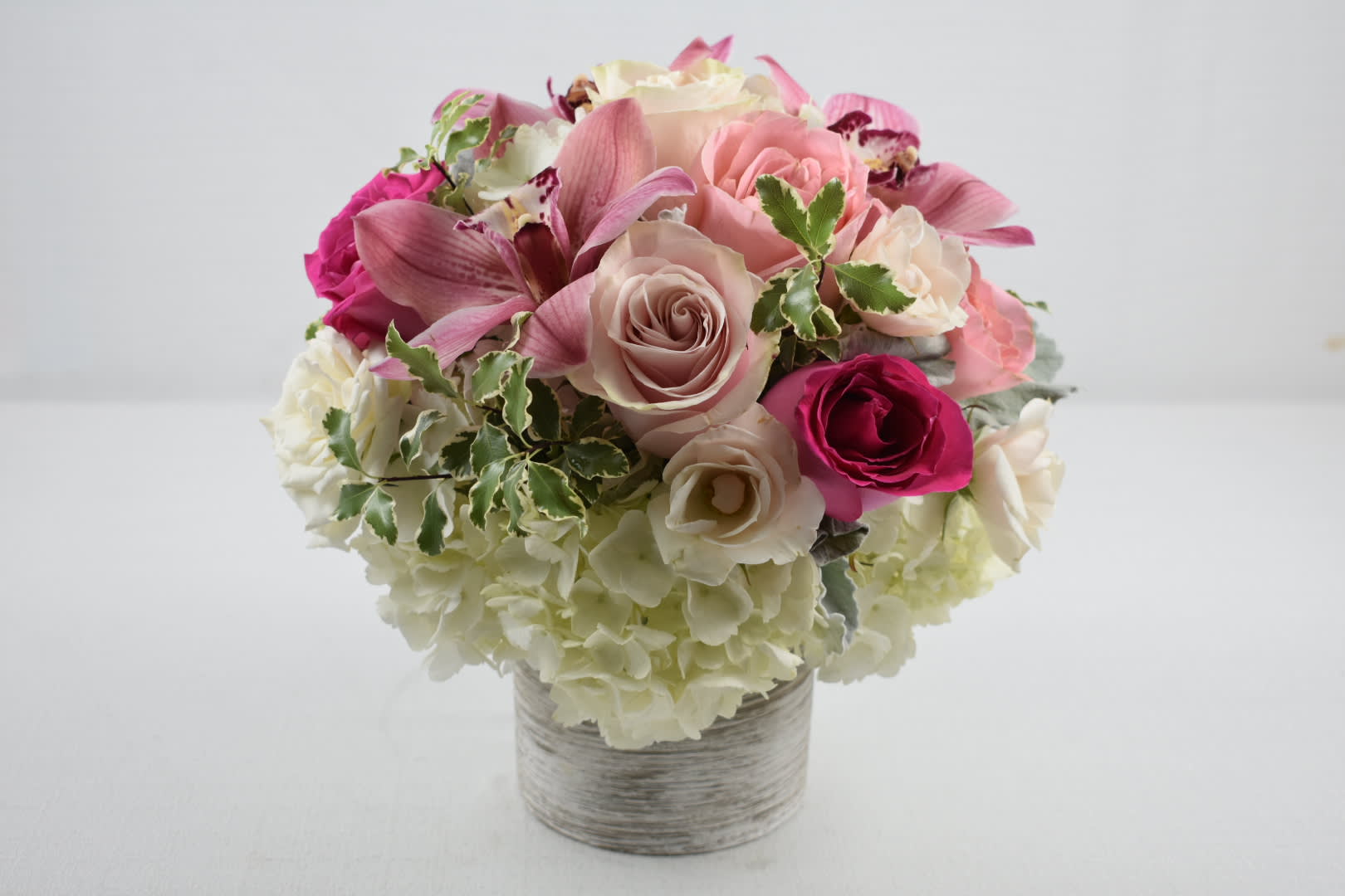 Paris - This beautiful small arrangement is the perfect gift for any occasion  It is created in a unique ceramic vase with White hydrangeas, two shades of pink Ecuadorian  roses, white spray roses, pink cymbidium and a touch of beautiful greenery   Perfect for  birthday flowers anniversary flower  just because flowers  congratulations flowers  Get well flowers  Christmas flowers Valentines Day flowers Mother's Day flowers