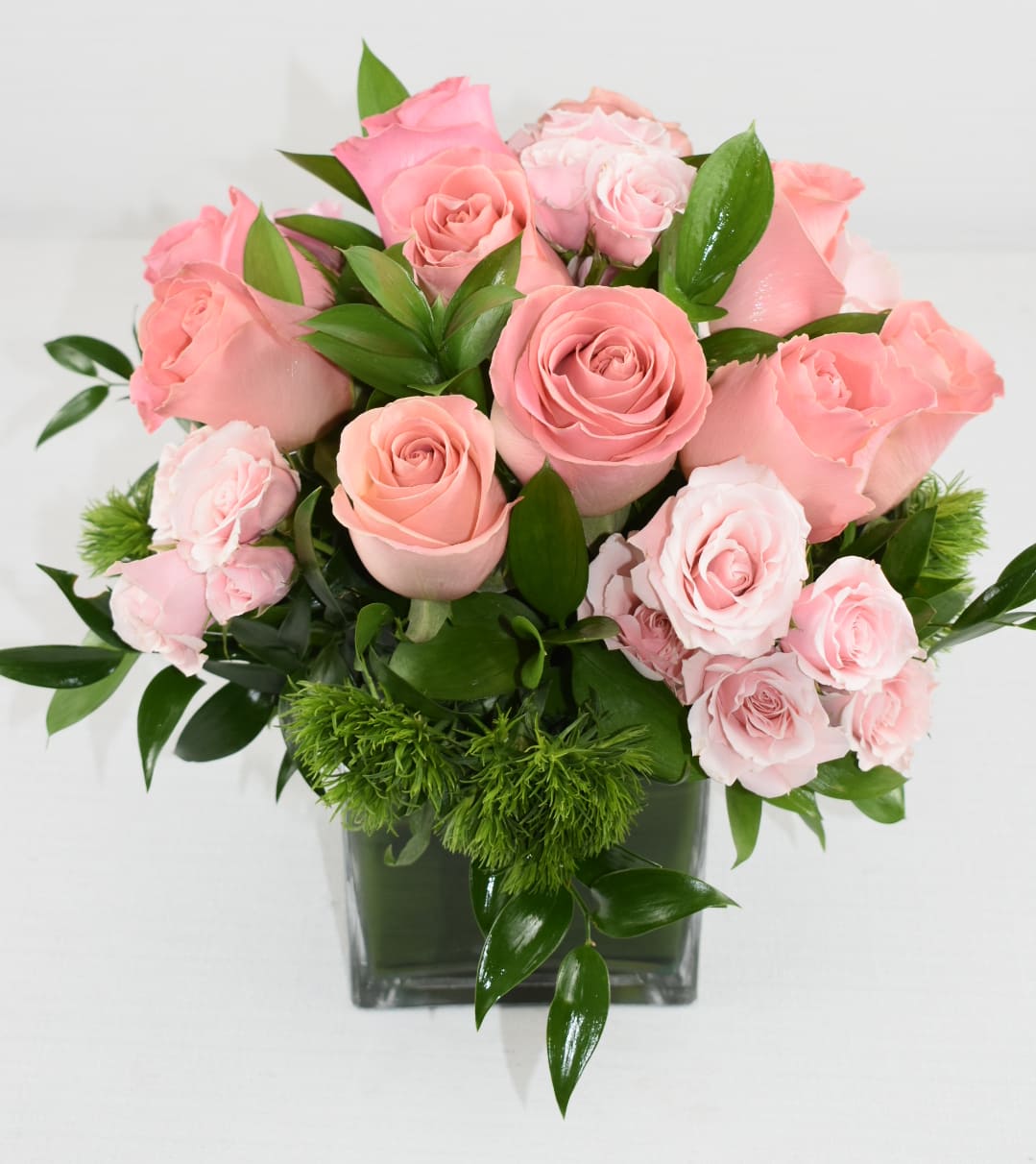 Make me blush - This arrangement will make them happy  Comes in a 5X7 vase with lovely greenery, pink Ecuadorian roses, spray pink roses  Perfect for any occasion 