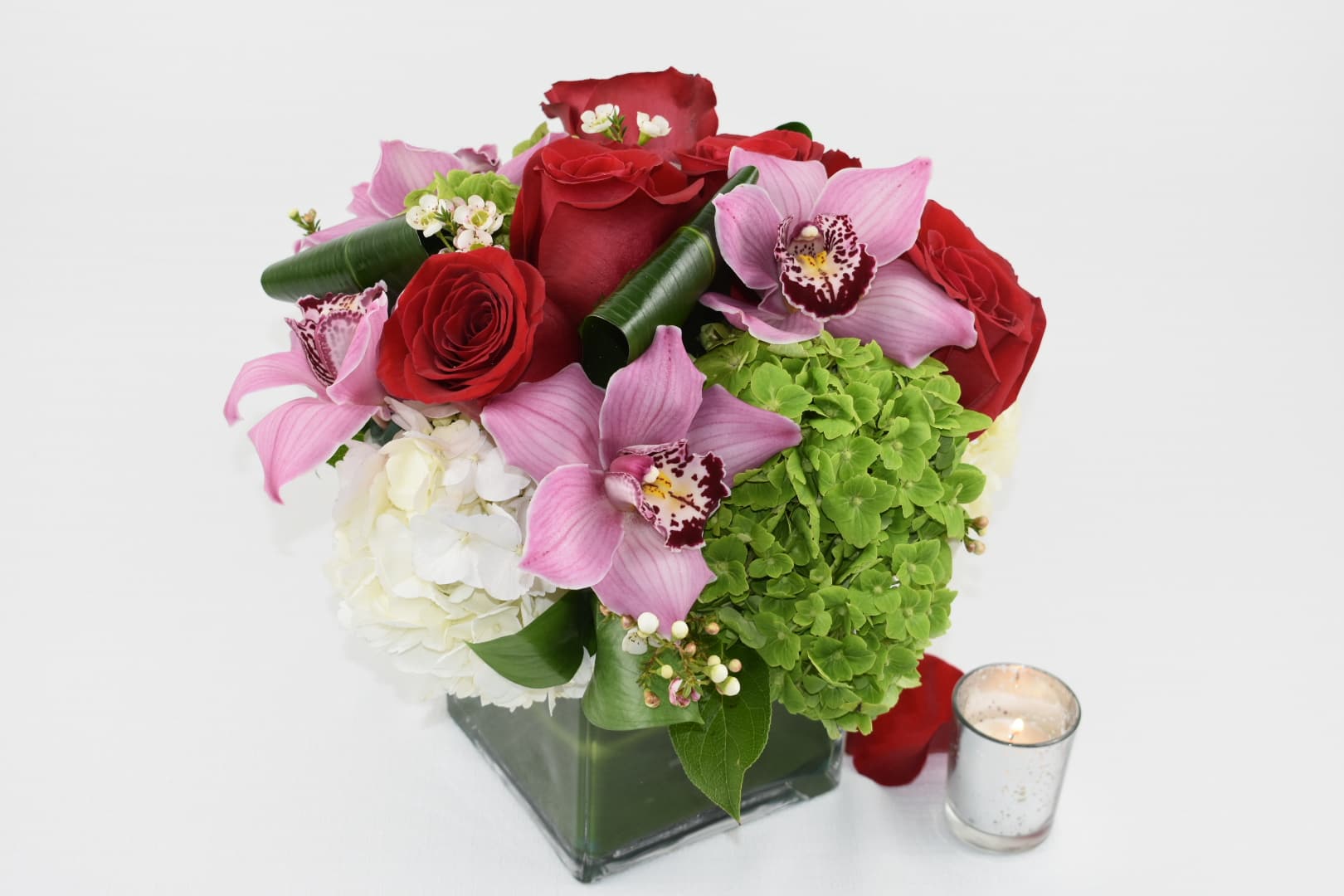 Oh!!! Baby - Just Beautiful  This floral arrangement comes in a square vase 5X5  contains white and green hydrangeas, Red Ecuadorian roses, pink cymbidiums orchids  Is Perfect for any occasion  Right size for an office desk   Perfect for  birthday flowers anniversary flower  just because flowers  congratulations flowers  Get well flowers  Christmas flowers Valentines Day flowers Mother's Day flowers