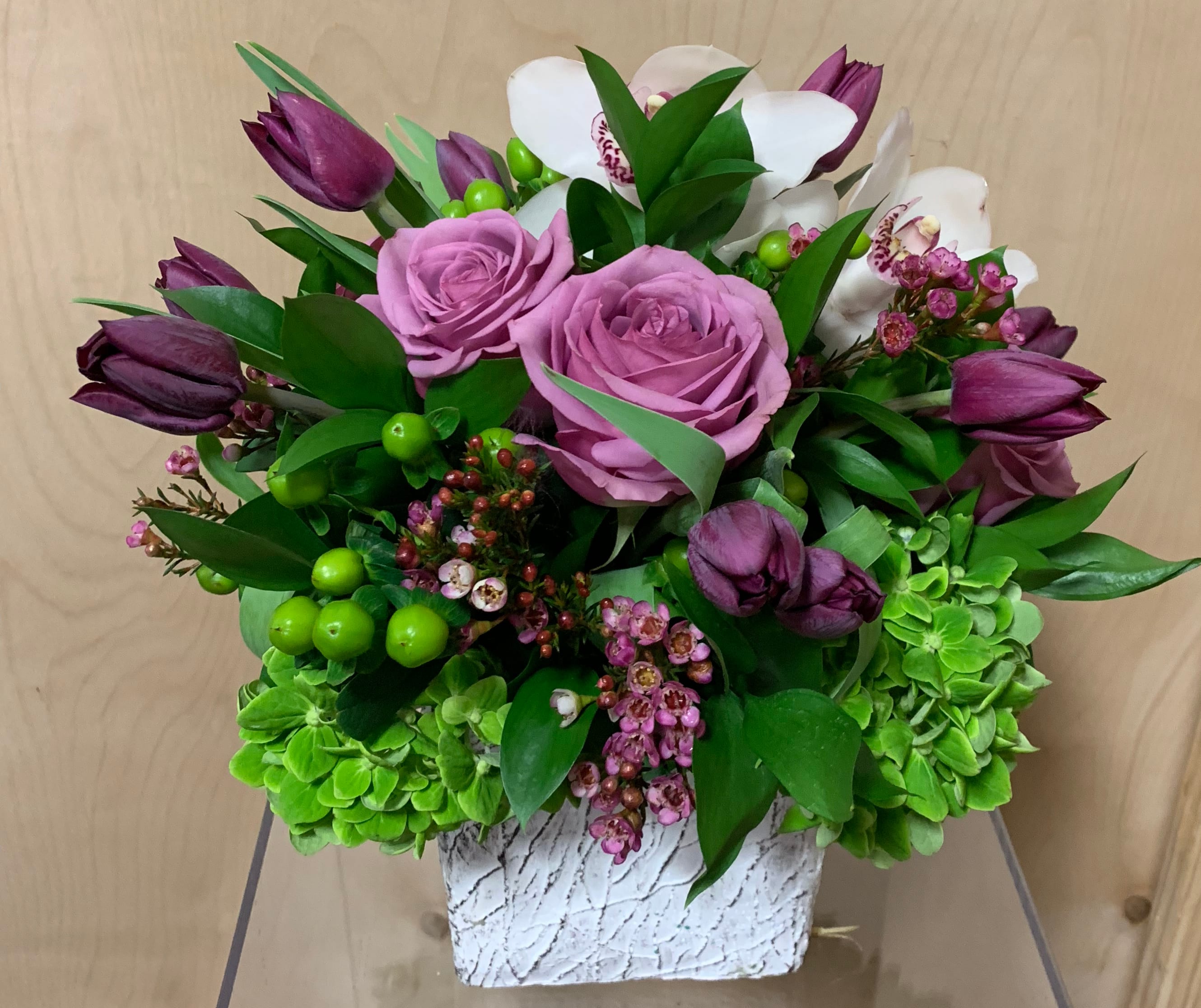 wild tulips  - Rustic white ceramic vase  Contains some beautiful purple tulips, Ecuadorian Lavender roses, green hydrangeas, purple wax, white cymbidium orchids  Perfect size for an office desk  Beautiful for any occasion  