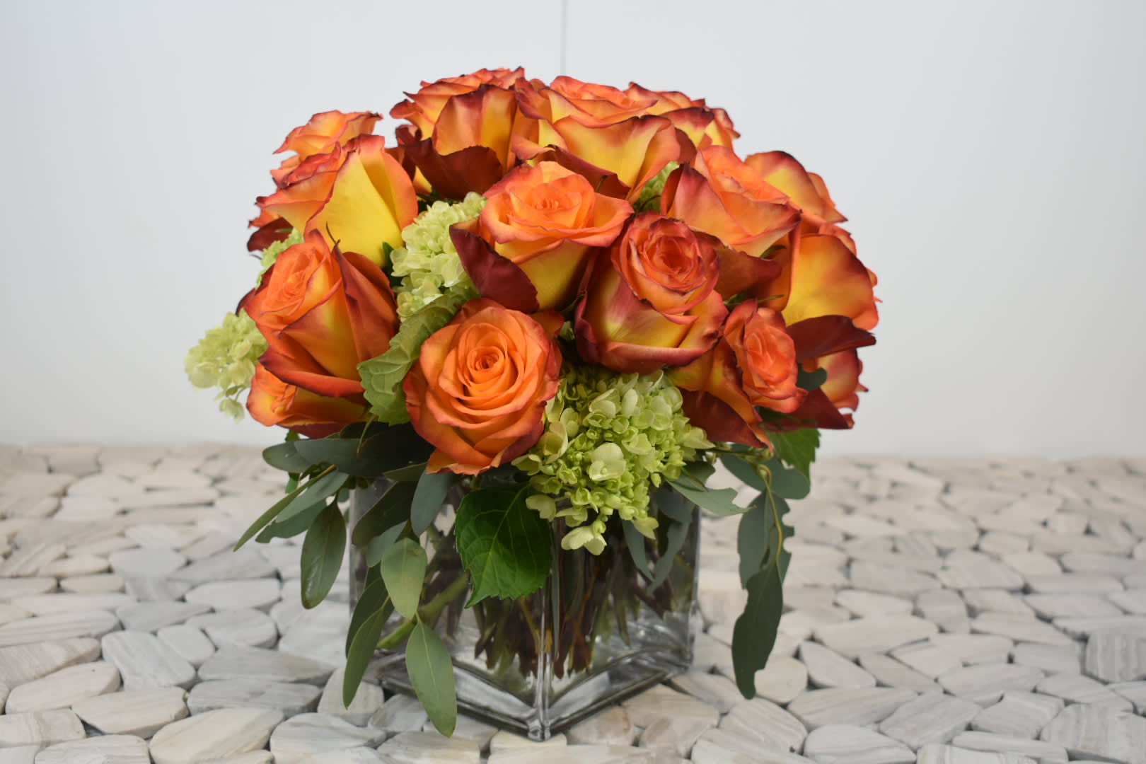 Mandarine  - This Tangerine design comes in a square glass vase with orange roses, lime green hydrangeas and the perfect touch of greenery    Perfect for  birthday flowers anniversary flower  just because flowers  congratulations flowers  Get well flowers  Christmas flowers Valentines Day flowers Mother's Day flowers