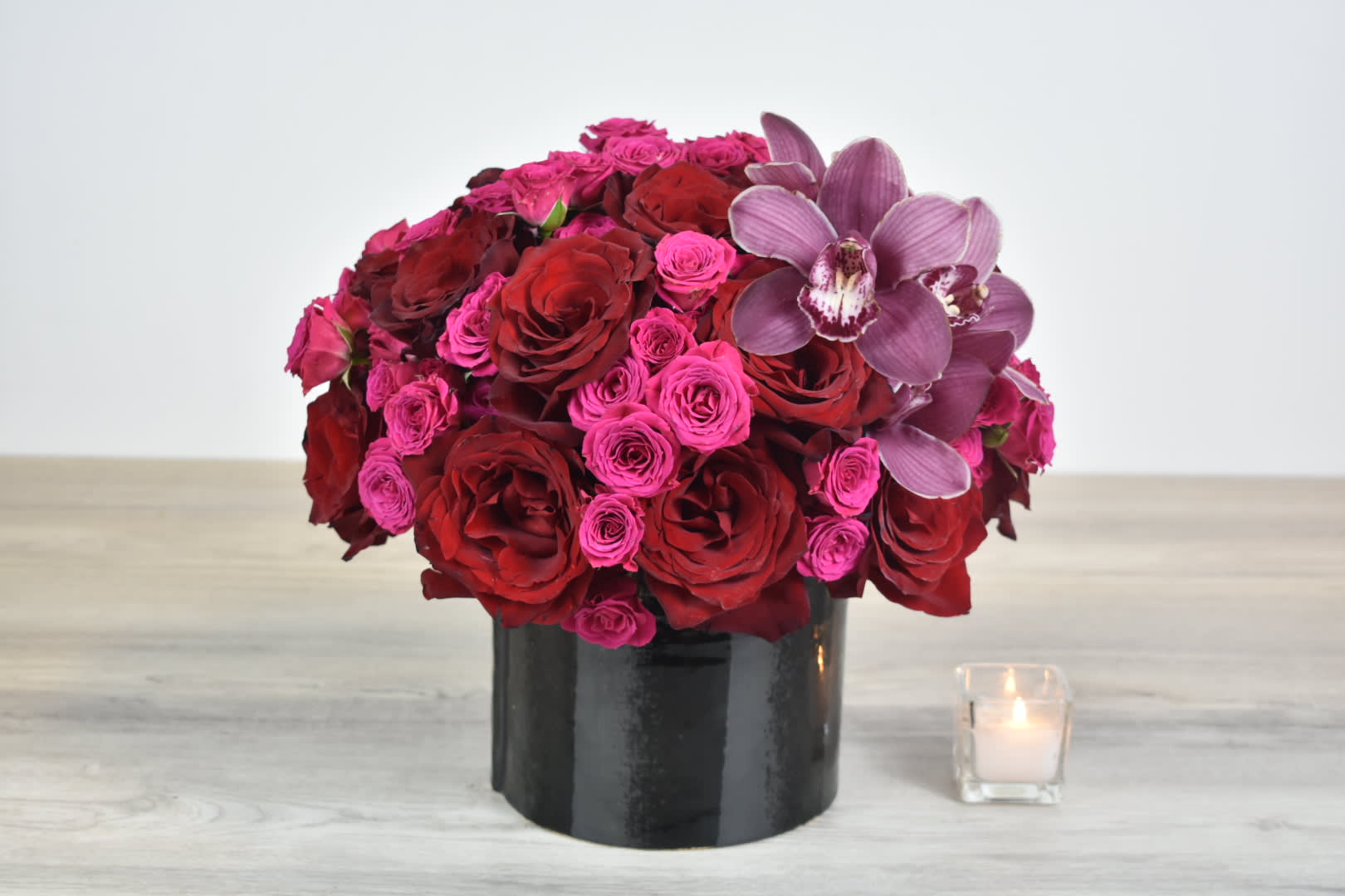 Dark Night  - Dark night design comes in a black ceramic vase with dark red roses, hot pink spray roses and burgundy cymbidium orchids  Perfect for  birthday flowers anniversary flower  just because flowers  congratulations flowers  Get well flowers  Christmas flowers Valentines Day flowers Mother's Day flowers