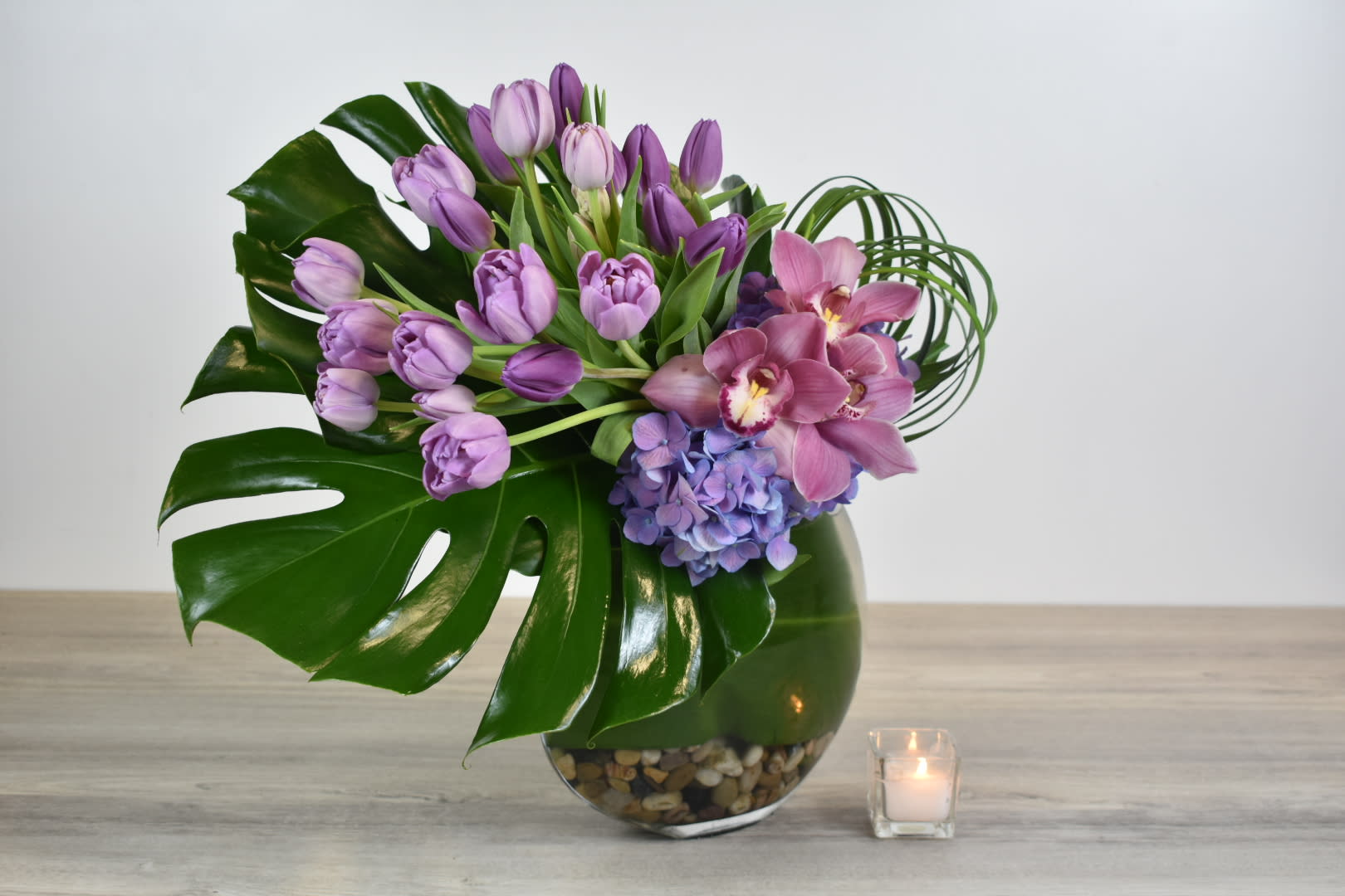 Violet - This Violet floral design comes in a glass vase, with purple tulips, purple hydrangeas, and pink cymbidium orchids.  Perfect for  birthday flowers anniversary flower  just because flowers  congratulations flowers  Get well flowers  Christmas flowers Valentines Day flowers Mother's Day flowers