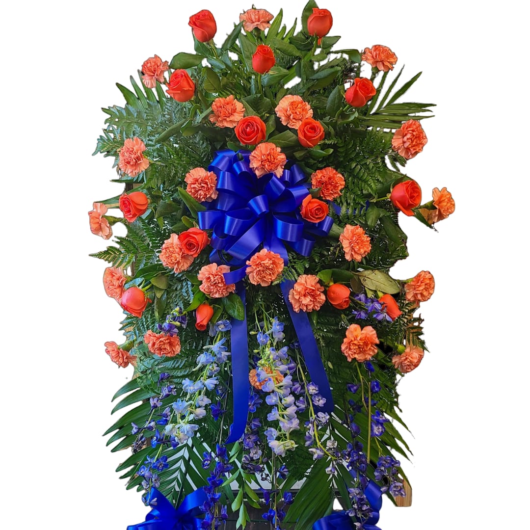 Standing floral spray with red roses, orange carnations, and blue ribbon