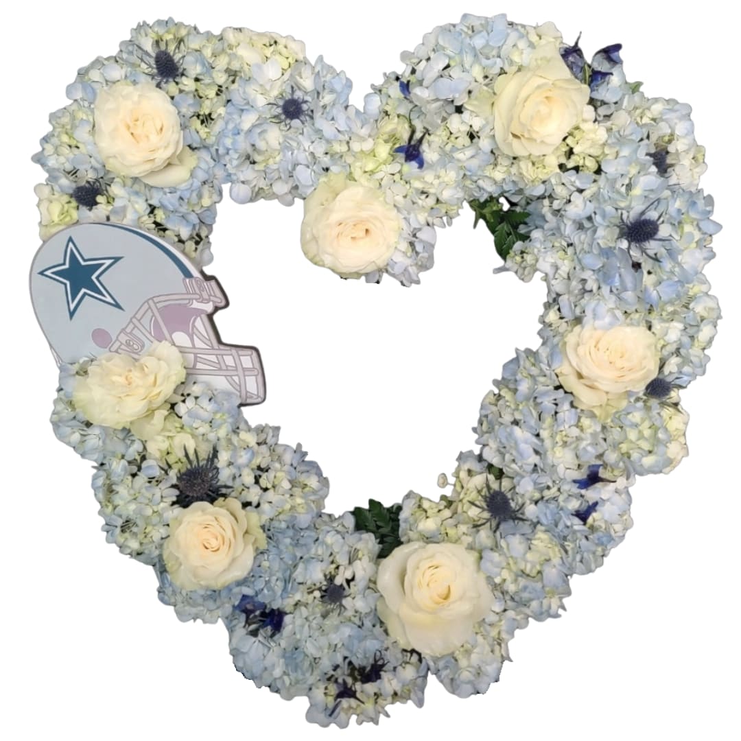 Heart-shaped floral arrangement with pale blue and white flowers and cream roses