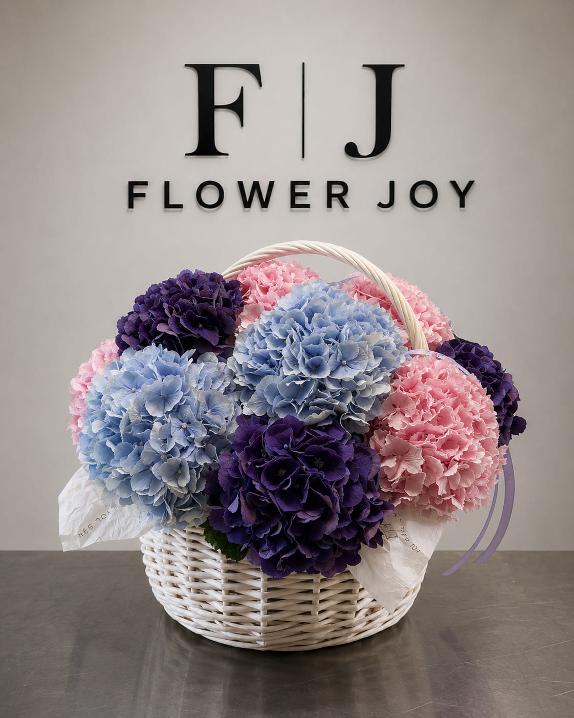 Basket of pink, blue, and purple hydrangeas with a handle