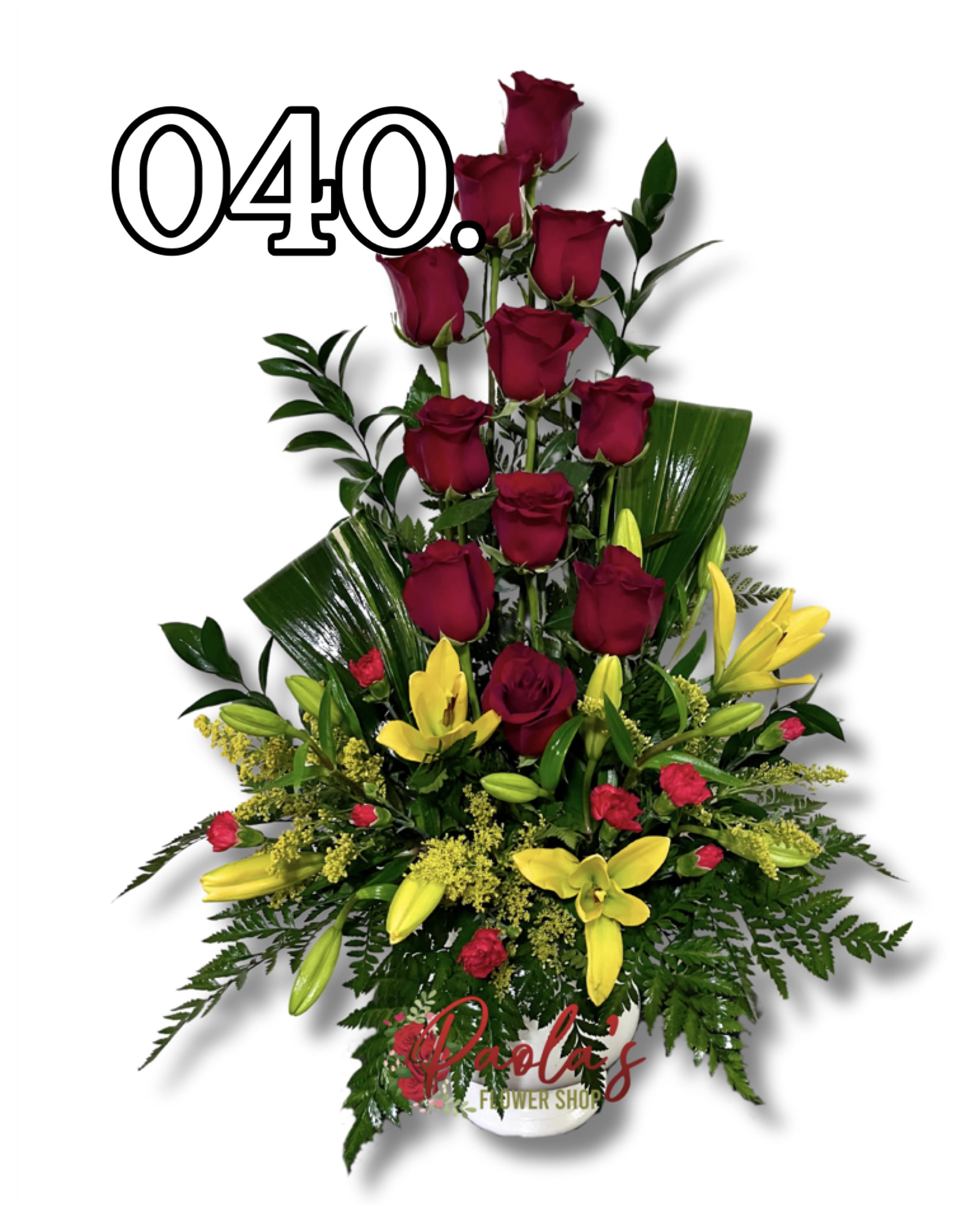 Tall arrangement of red roses and yellow lilies in a white vase