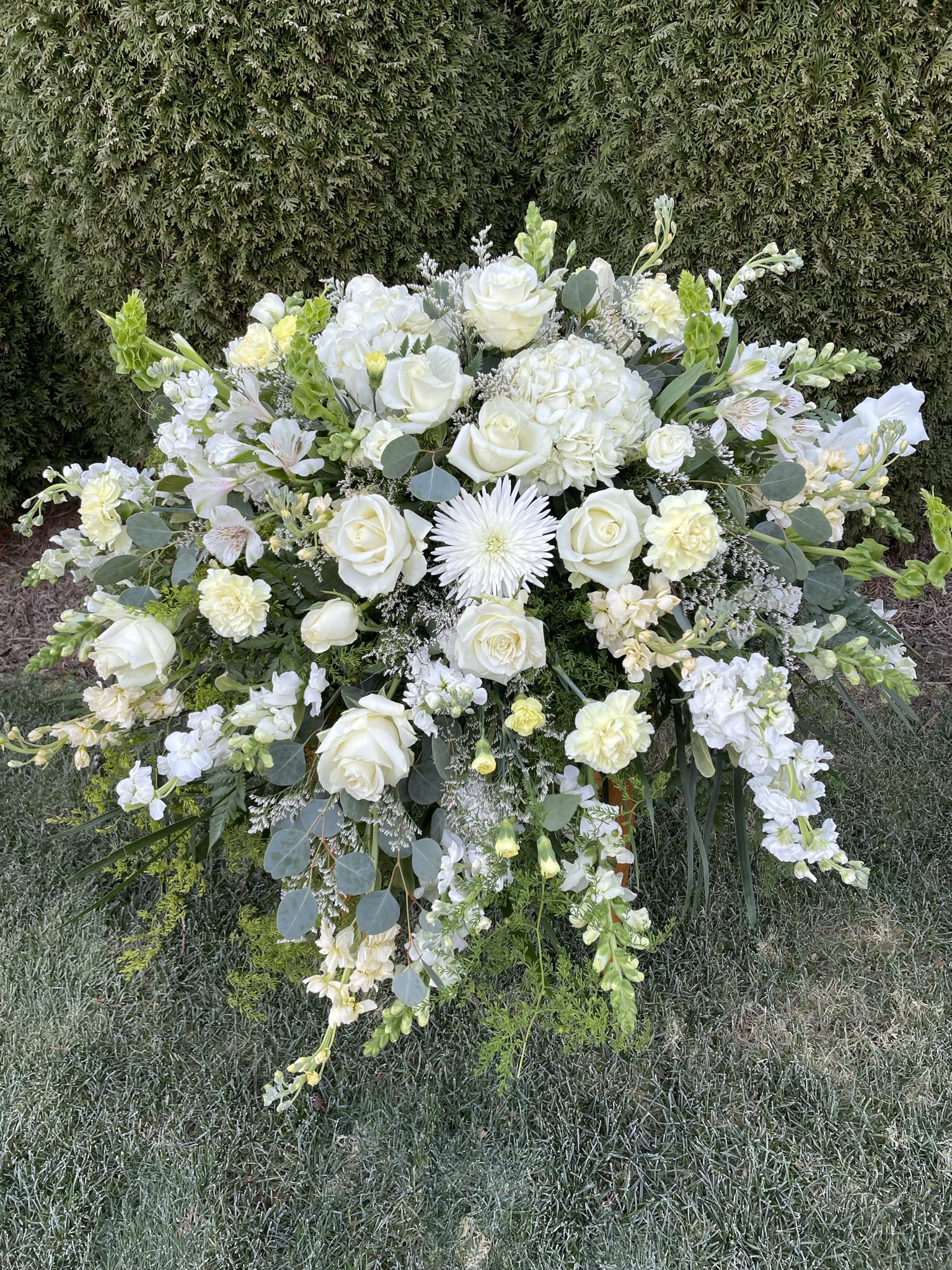 Large white floral spray with roses and hydrangeas