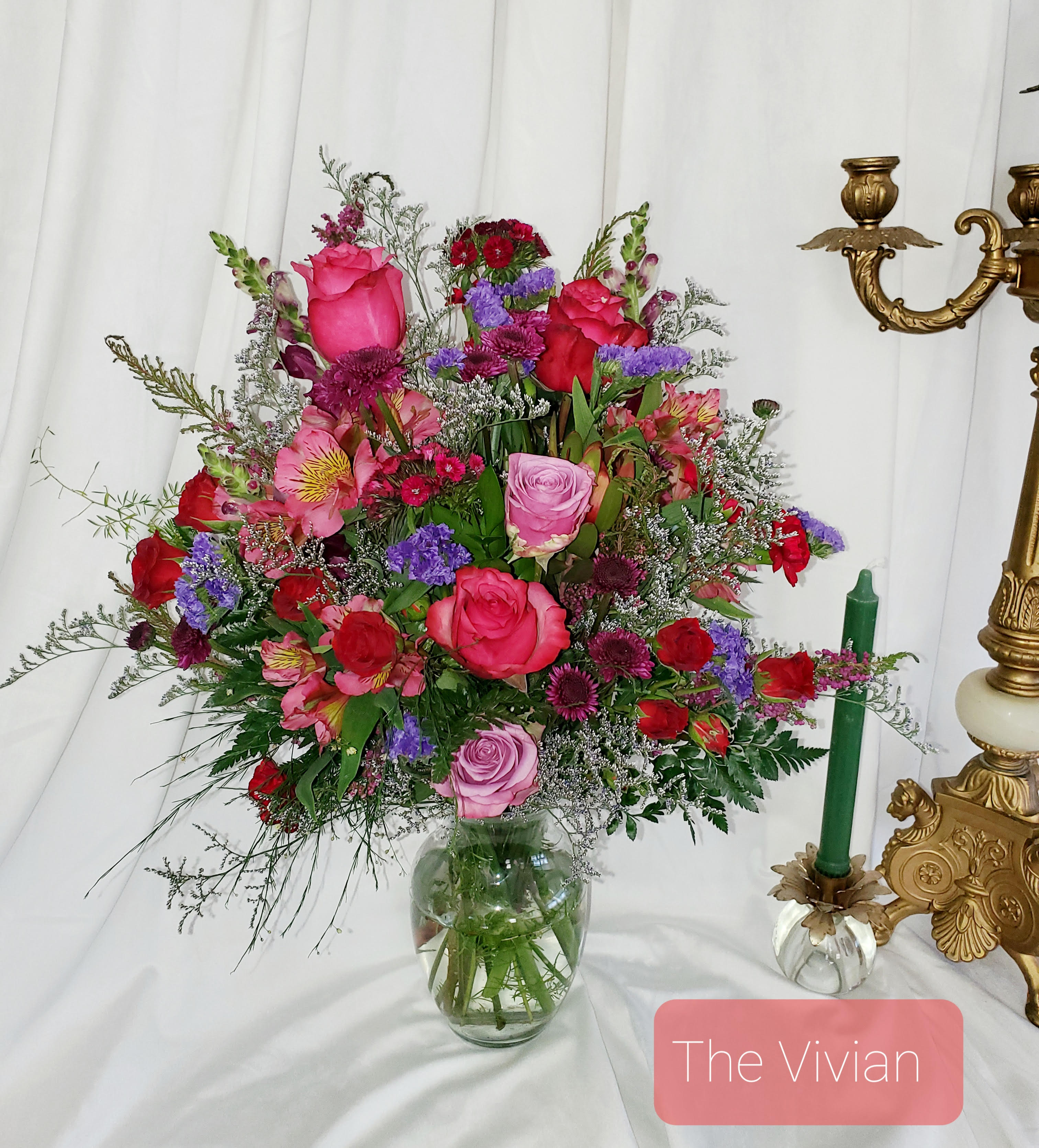 Mixed bouquet of pink and red roses in a glass vase
