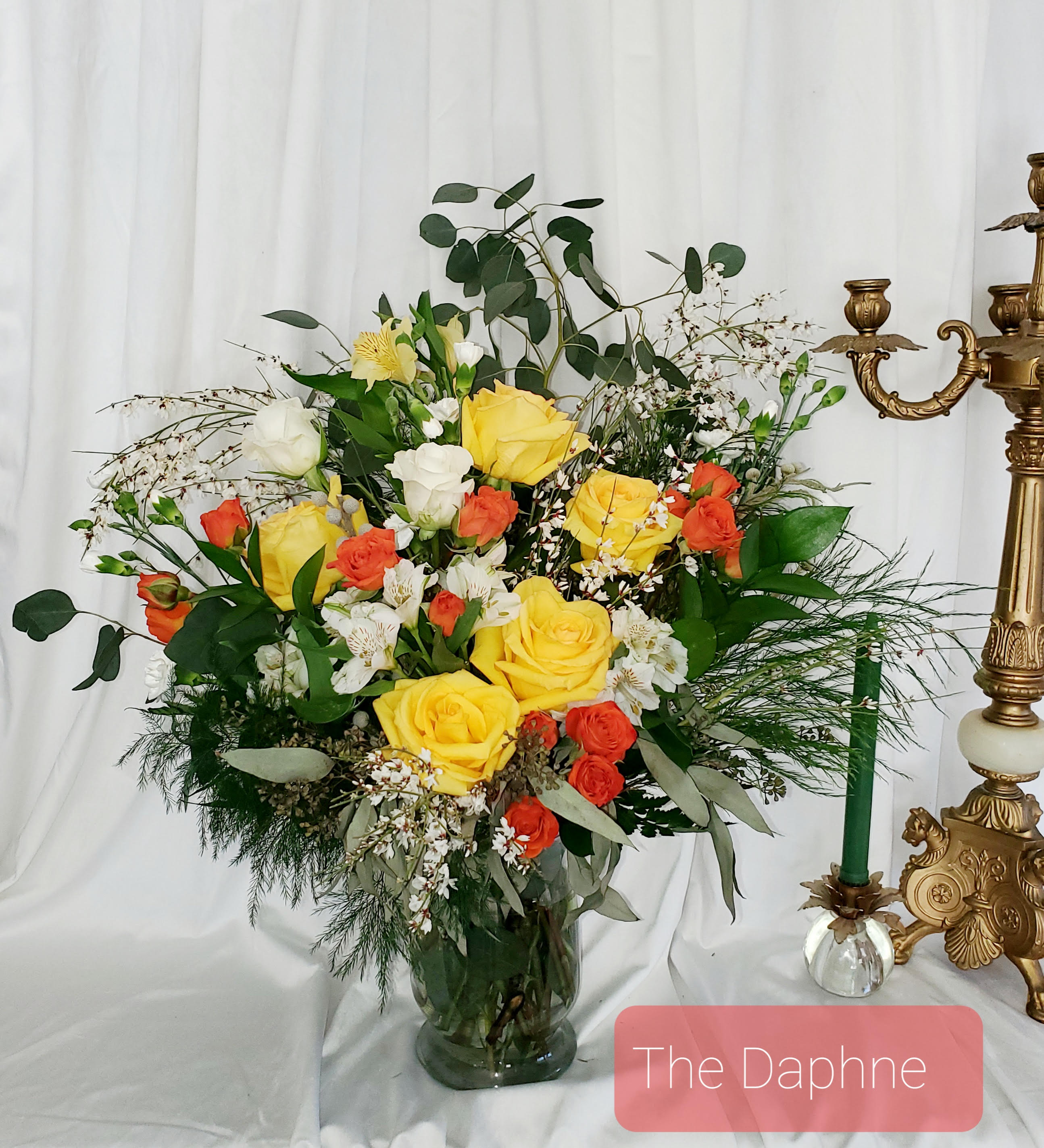 Yellow and orange rose arrangement in a glass vase