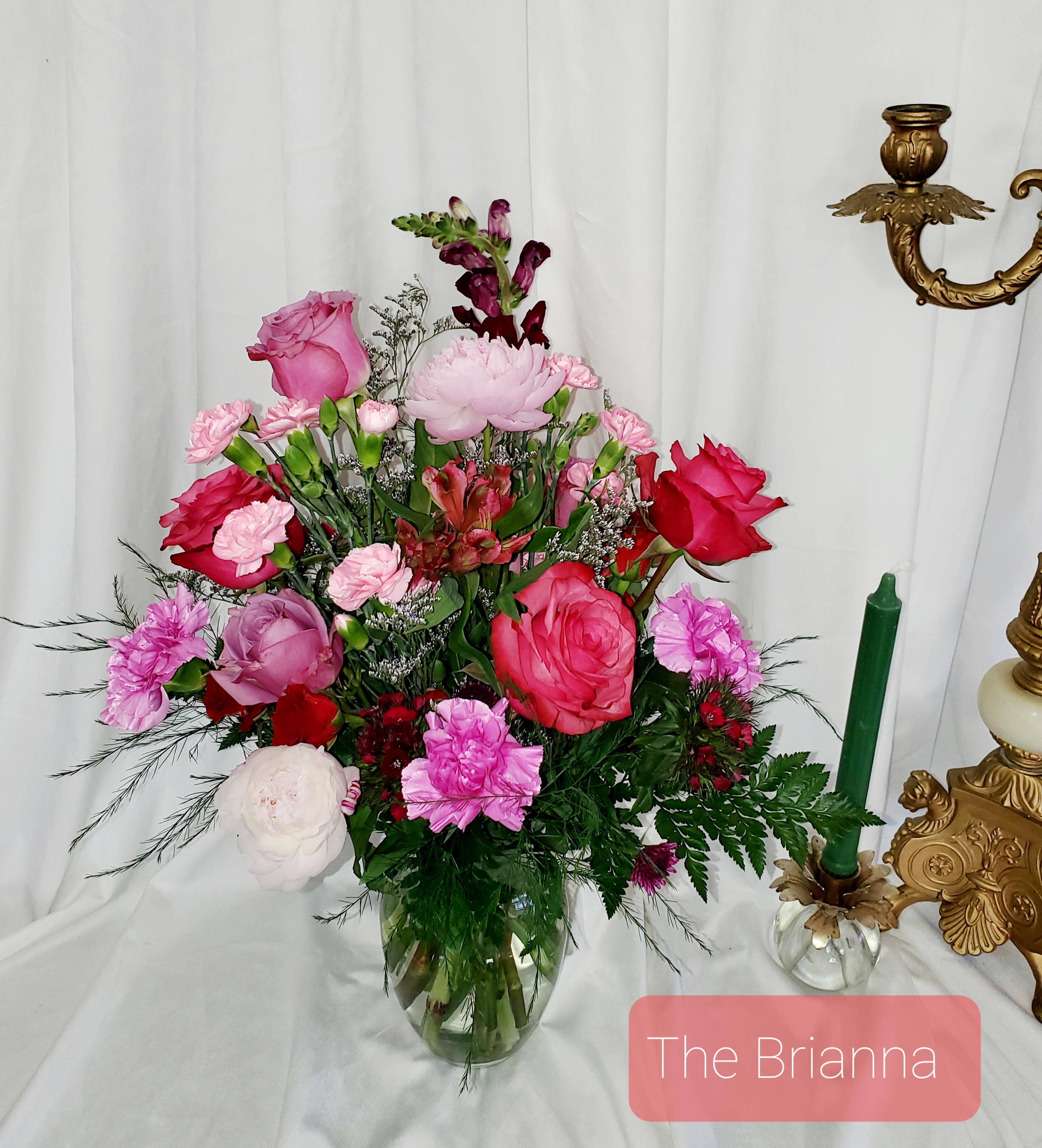 Pink and red mixed flower arrangement in a glass vase