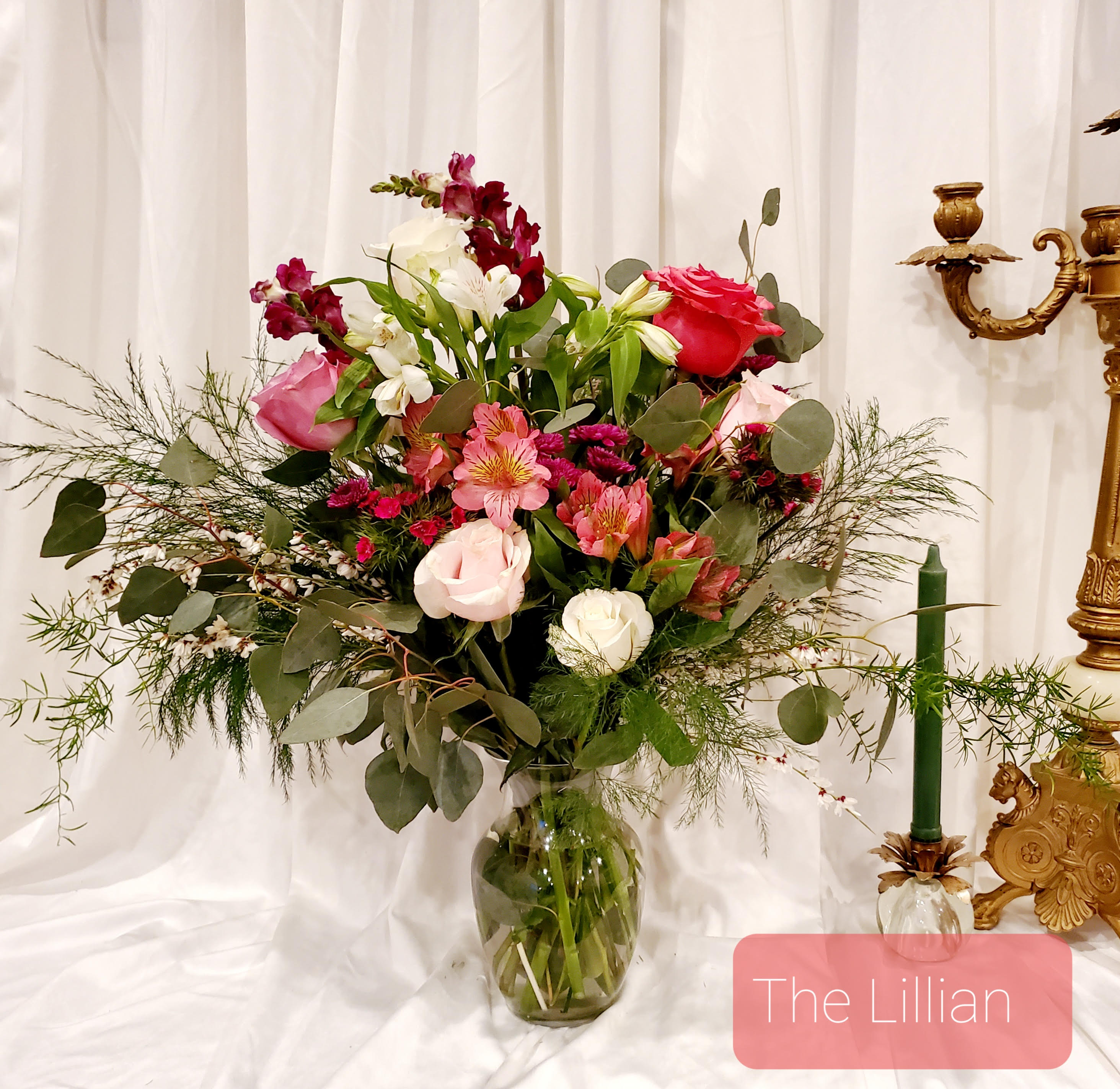 Mixed pink and white flower arrangement in a glass vase