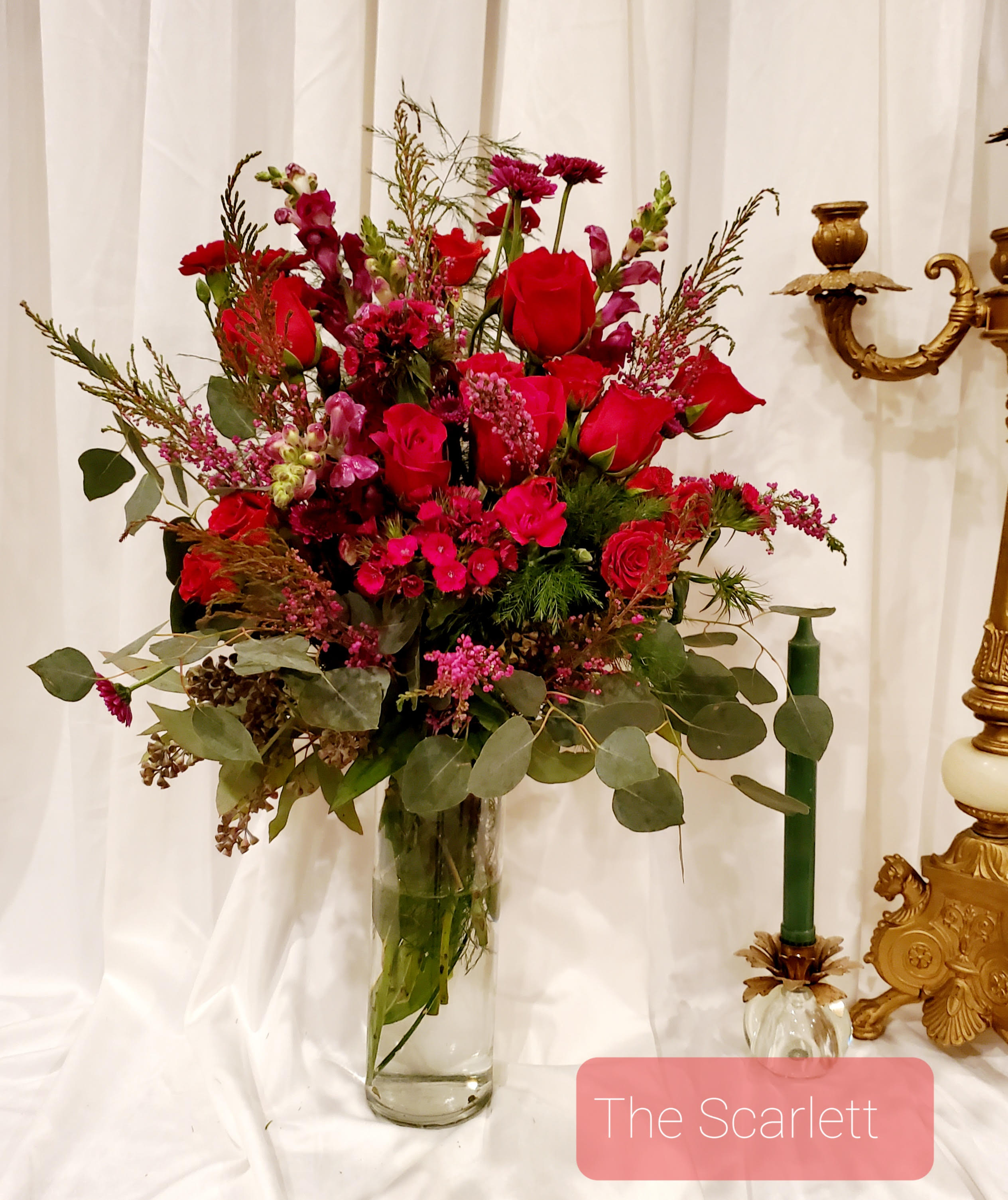 Red floral arrangement in a clear glass vase