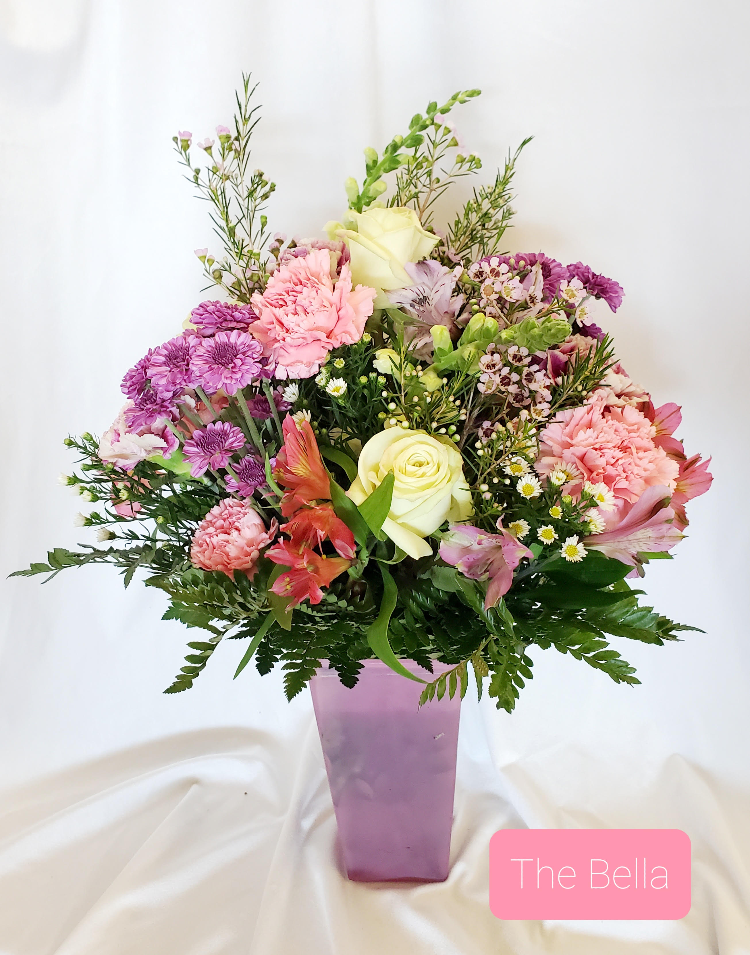 Mixed pink and white bouquet in a purple vase