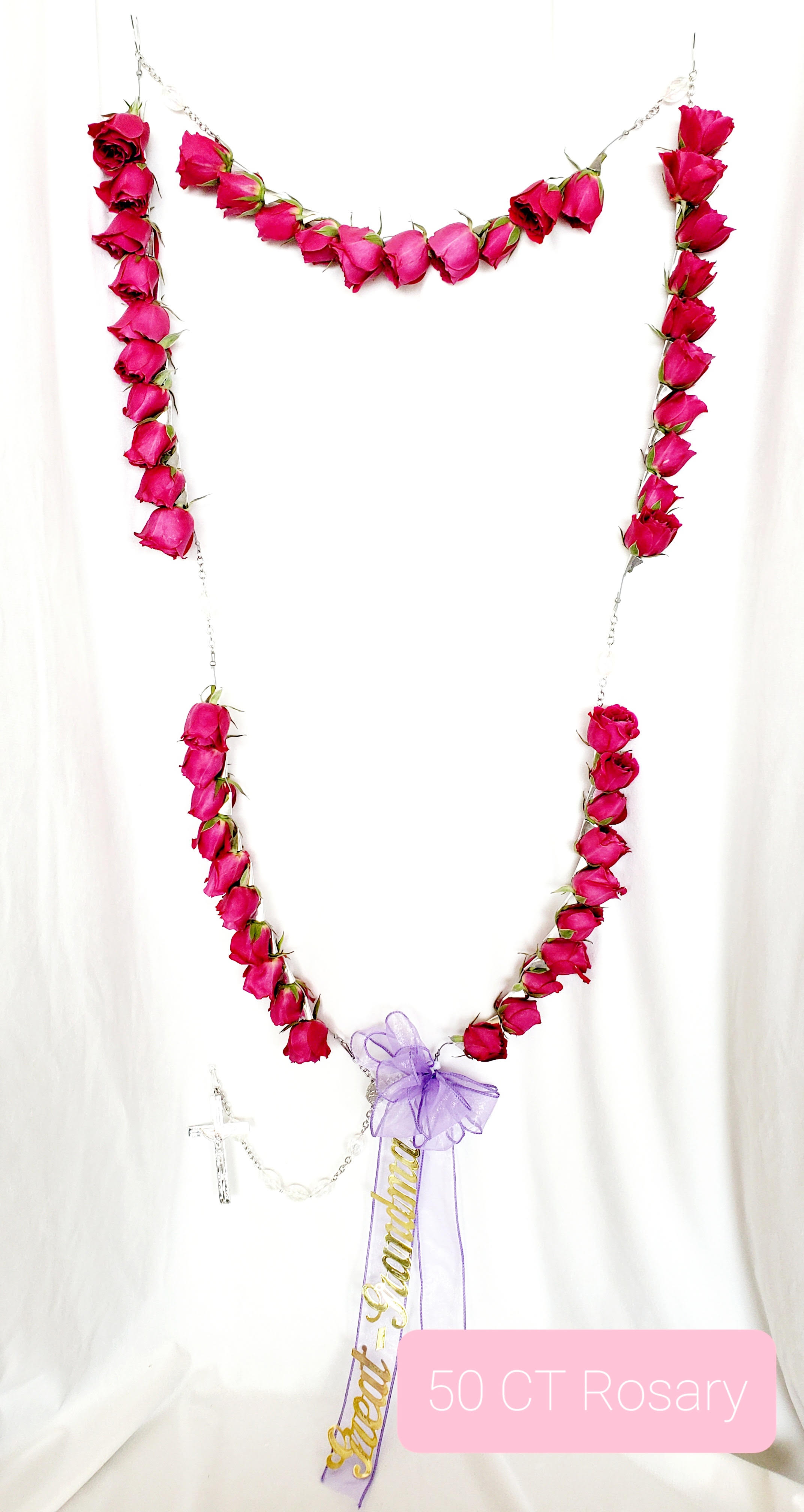 Pink rose rosary with a purple bow and cross pendant