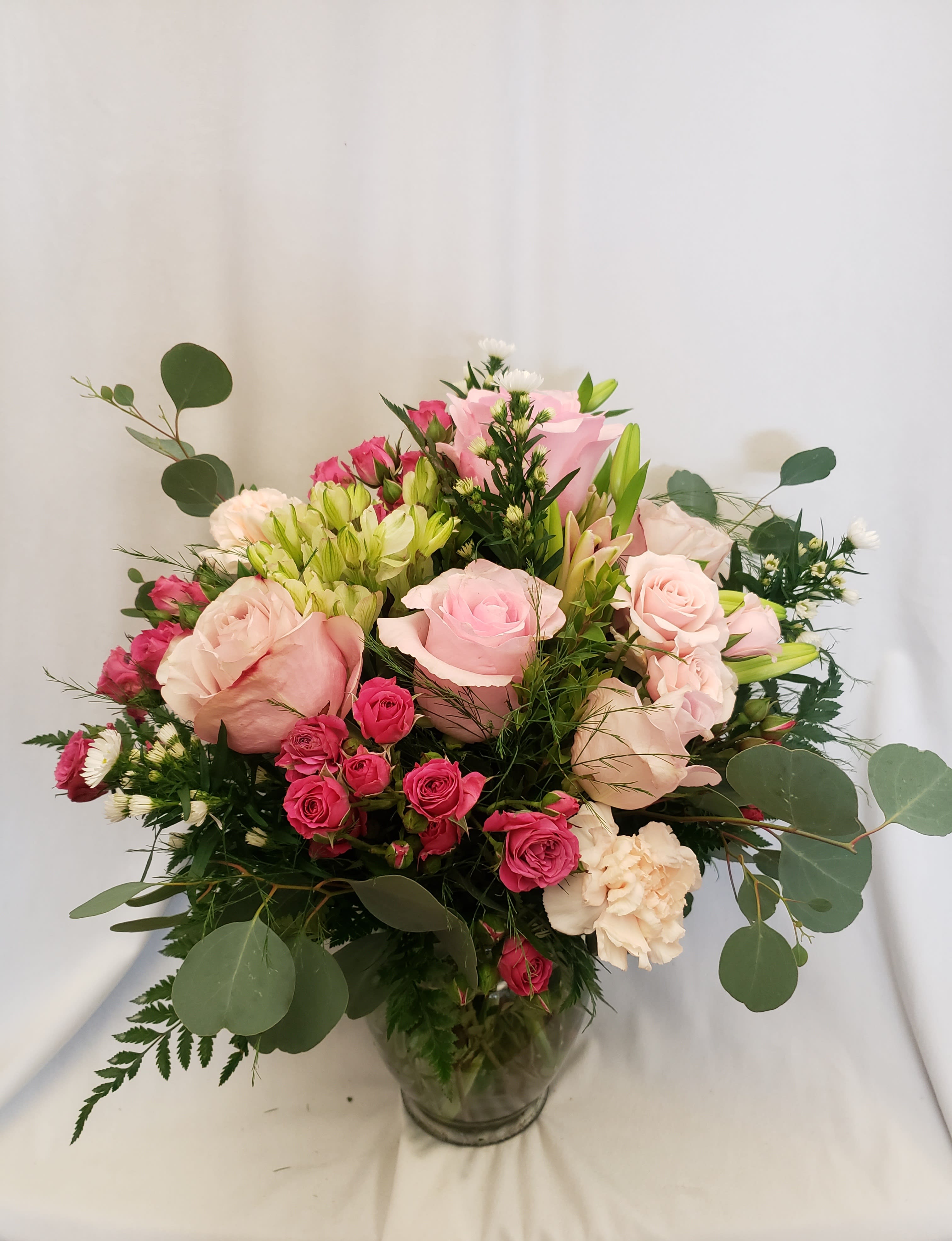 Pink and cream rose bouquet in a glass vase