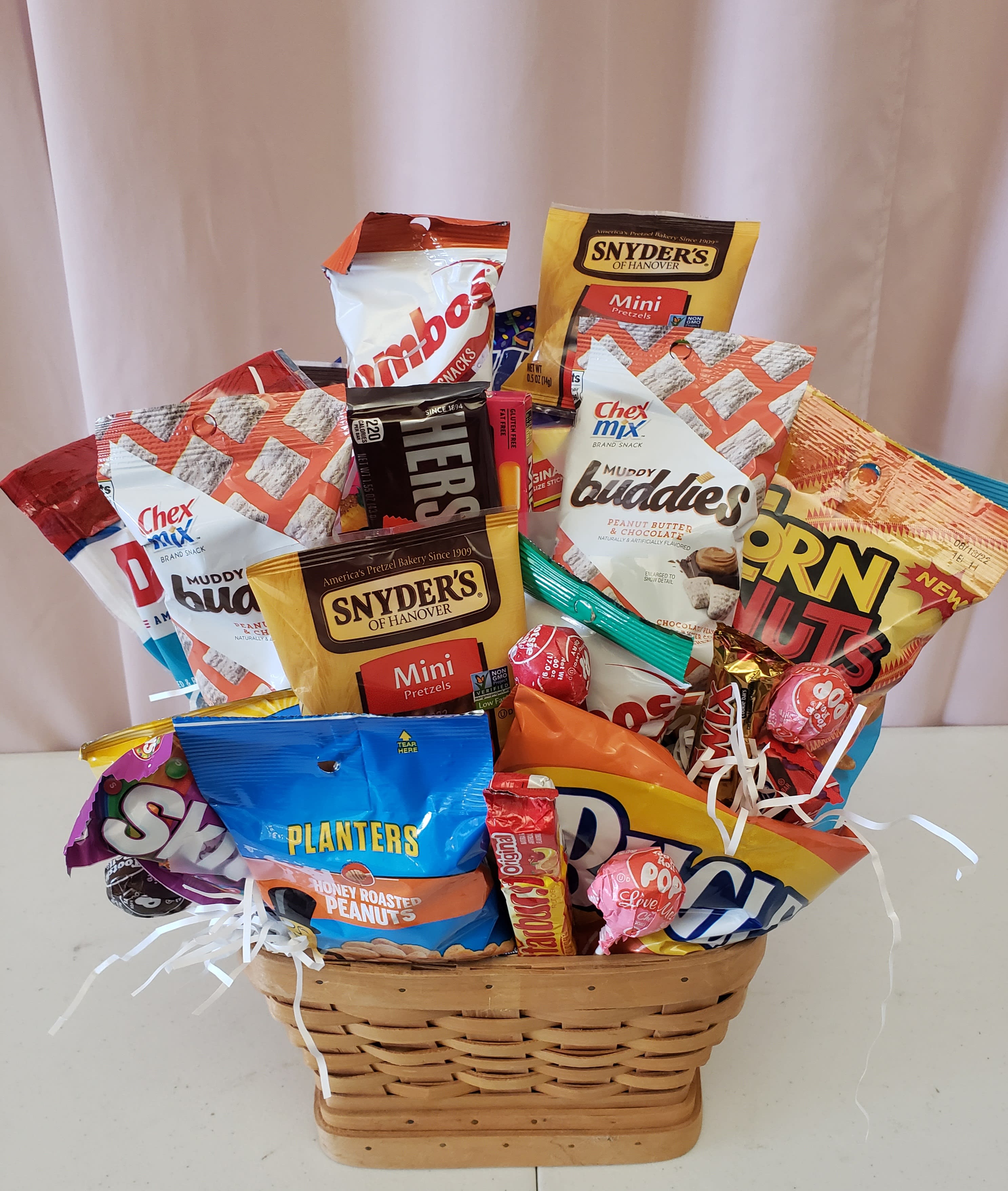 Basket of assorted snack bags and candy on a table