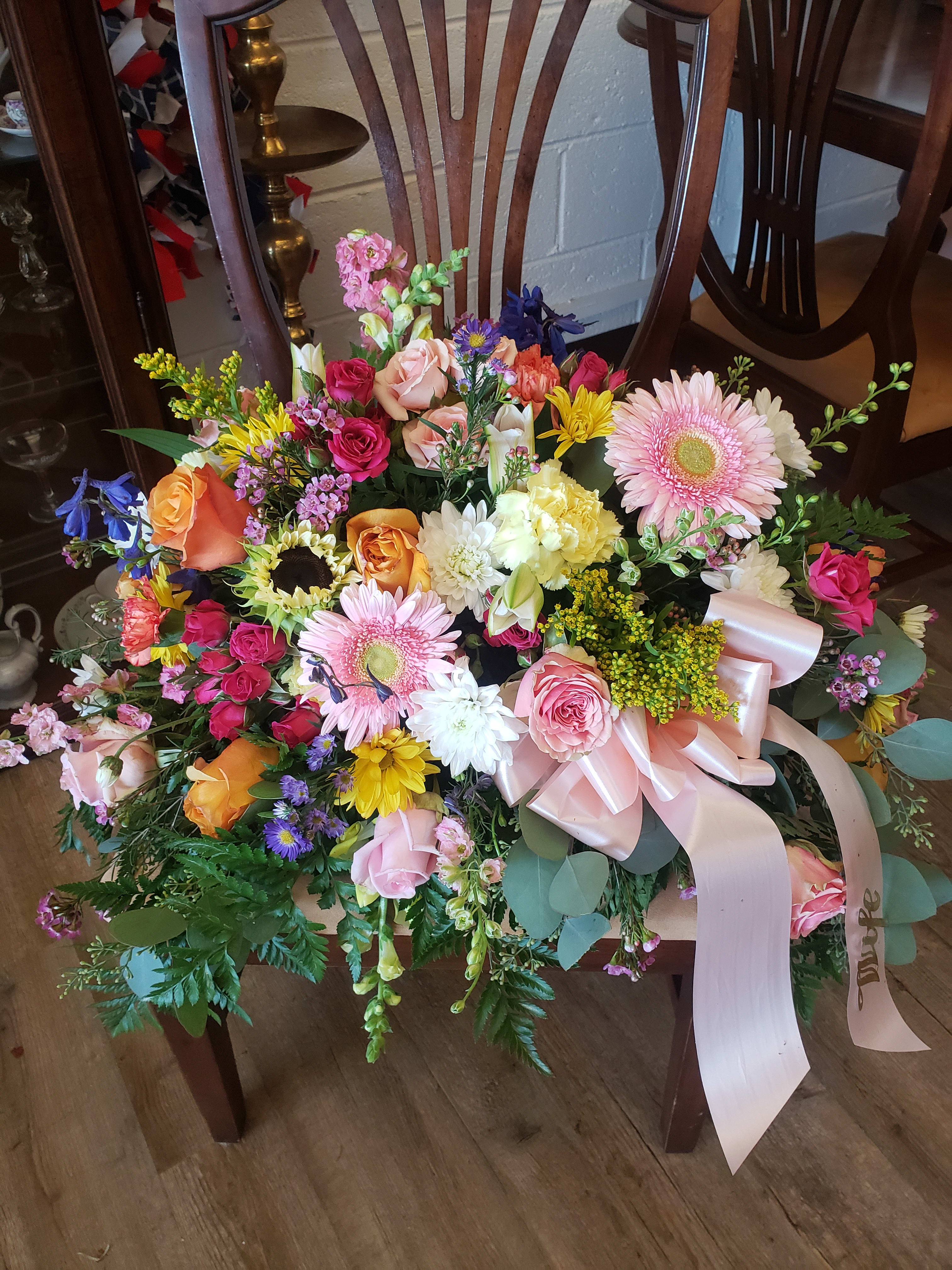 Large mixed bouquet with pink roses, gerbera daisies, and a pale ribbon