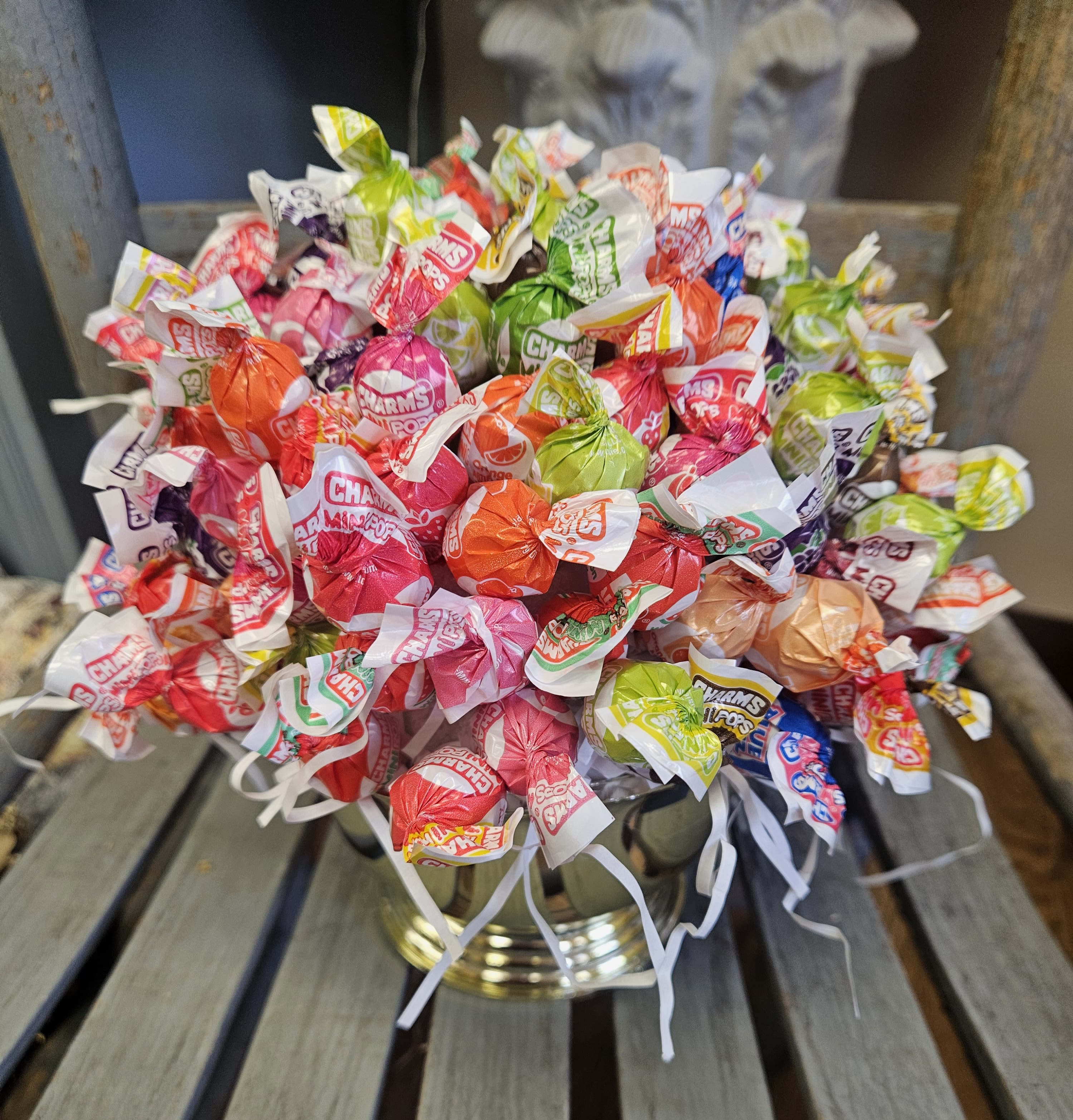 Bouquet of colorful wrapped candies in a gold vase