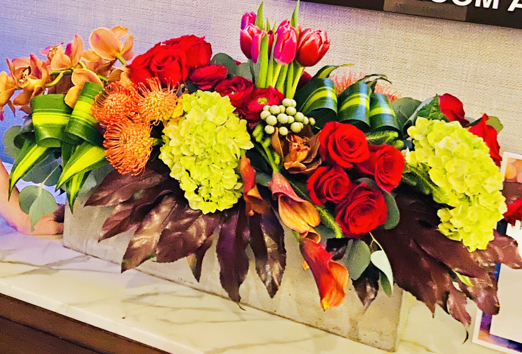 Colorful mixed floral arrangement in a rectangular container
