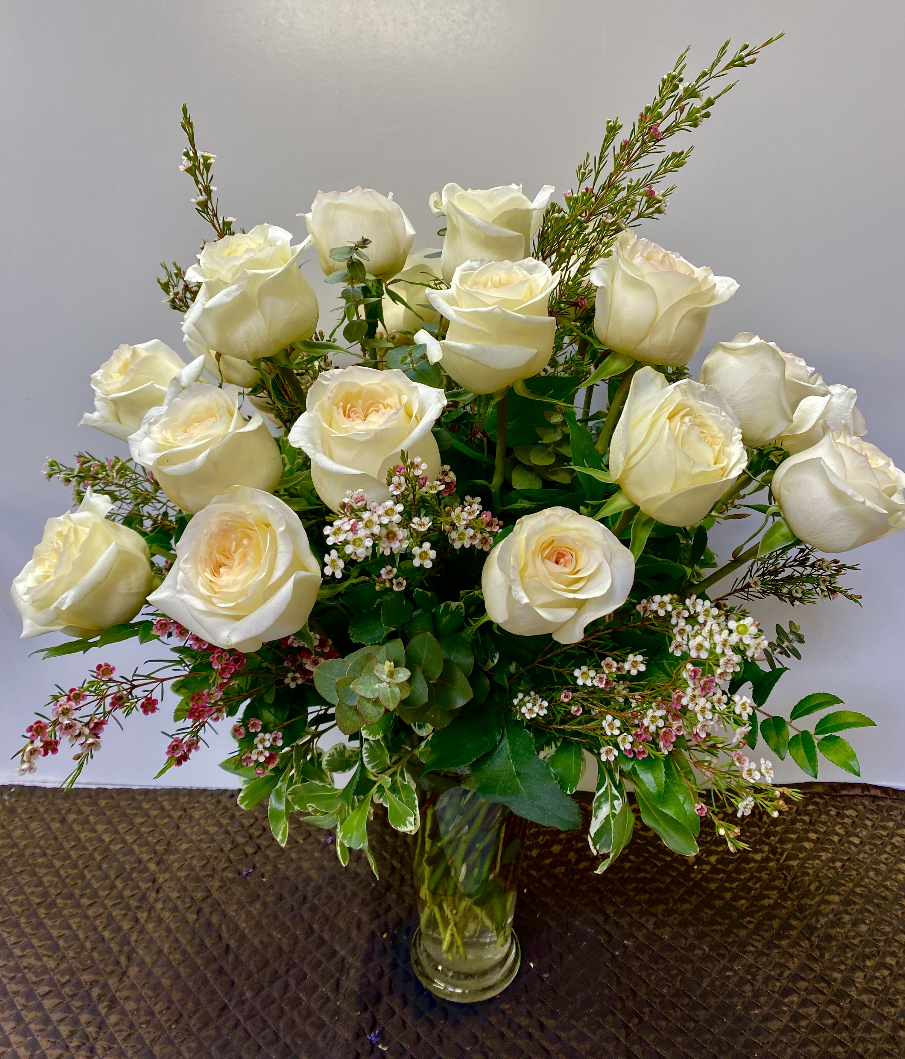 Bouquet of white roses in a clear glass vase