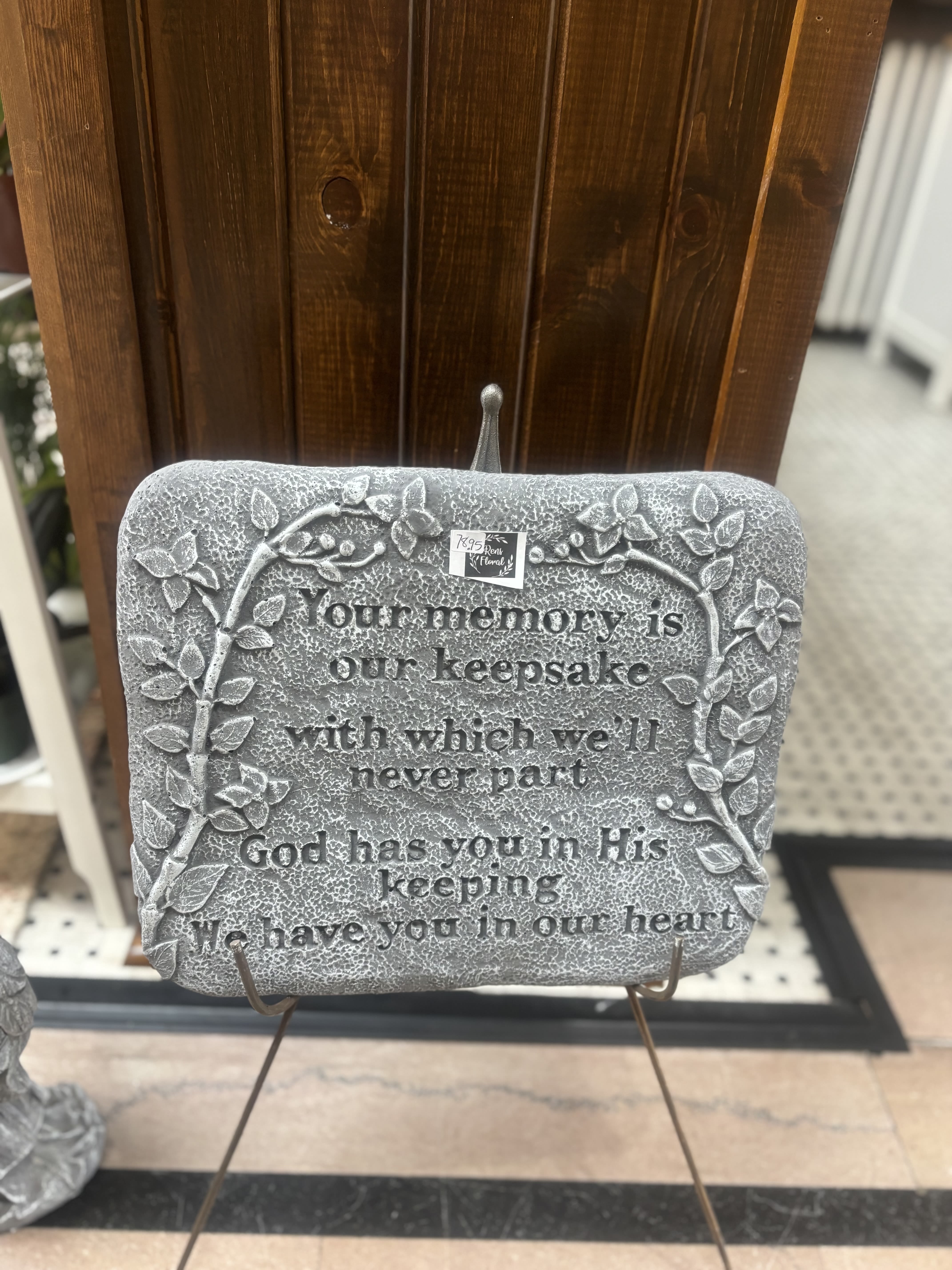 Decorative memorial plaque on a stand with a sympathy quote